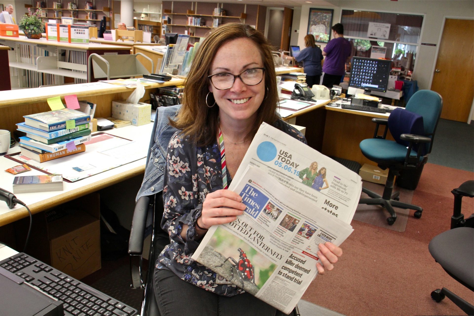 Upper Merion reference librarian Kristine Pennese keeps the most popular newspapers, the Times Herald and USA Today, behind the desk so they don't disappear.