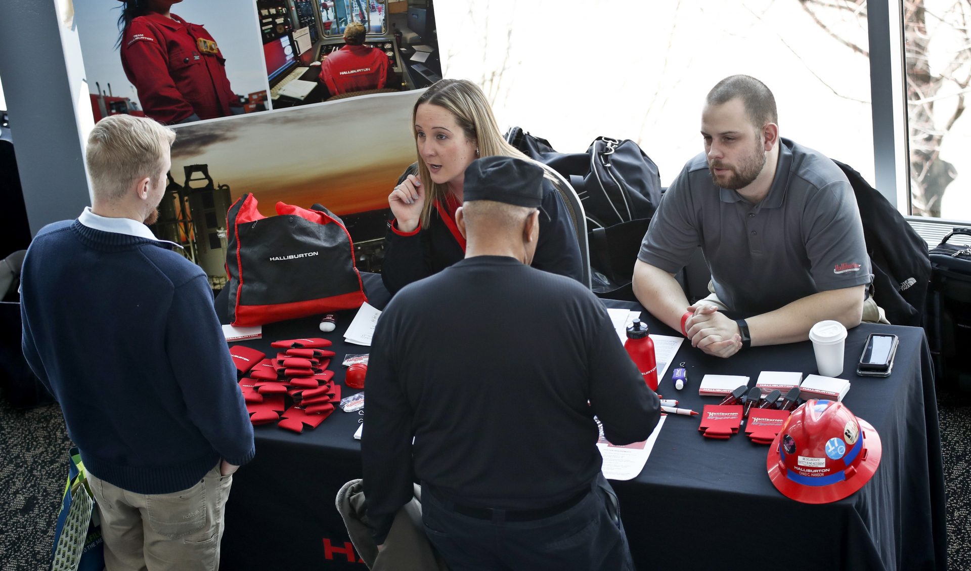 In this March 7, 2019, file photo, visitors to the Pittsburgh veterans job fair meet with recruiters at Heinz Field in Pittsburgh.