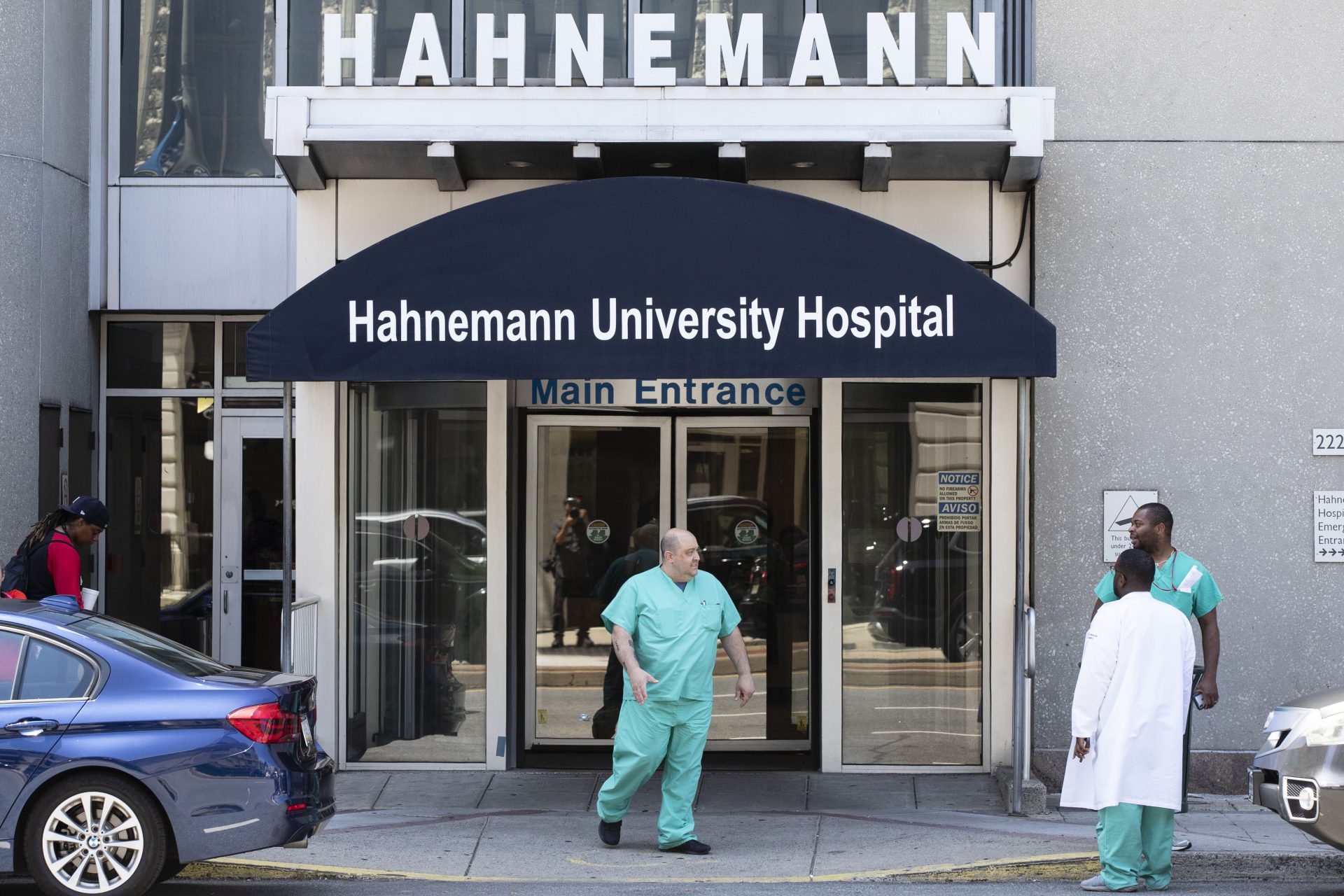A person exits Hahnemann University Hospital in Philadelphia, Wednesday, June 26, 2019. The owner of hospital has announced it will close in September because of what the company calls "continuing, unsustainable financial losses."
