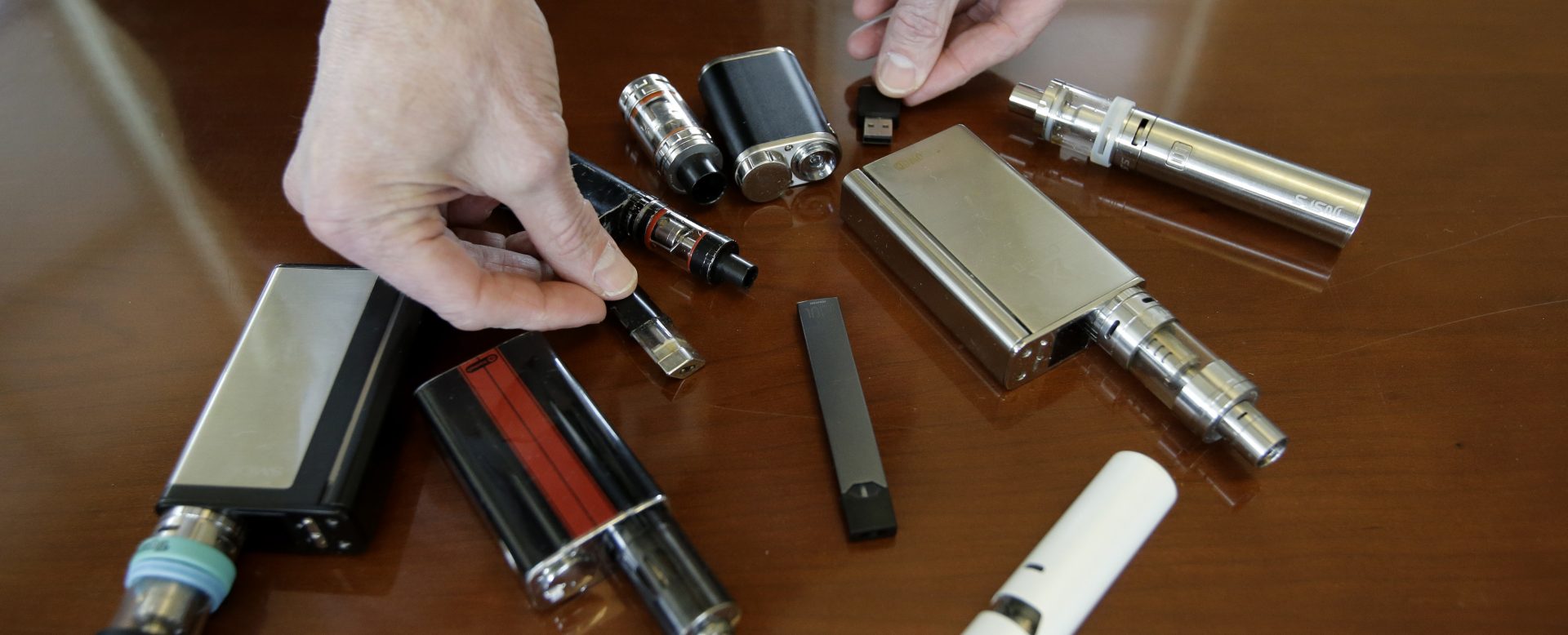 FILE PHOTO: In this Tuesday, April 10, 2018 file photo Marshfield High School Principle Robert Keuther displays vapes that were confiscated from students in Marshfield, Mass.