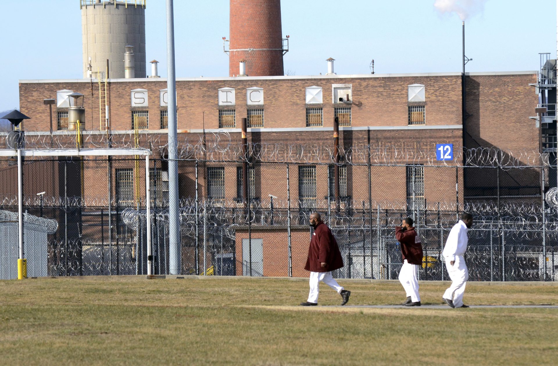 Inmates walk across a yard at the State Correctional Institution at Camp Hill, Pennsylvania, Friday, Jan. 13, 2017, in Camp Hill, Pa.