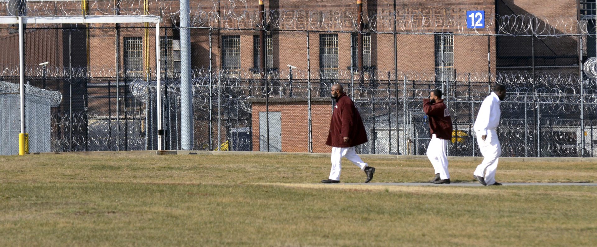 Inmates walk across a yard at the State Correctional Institution at Camp Hill, Pennsylvania, Friday, Jan. 13, 2017, in Camp Hill, Pa.