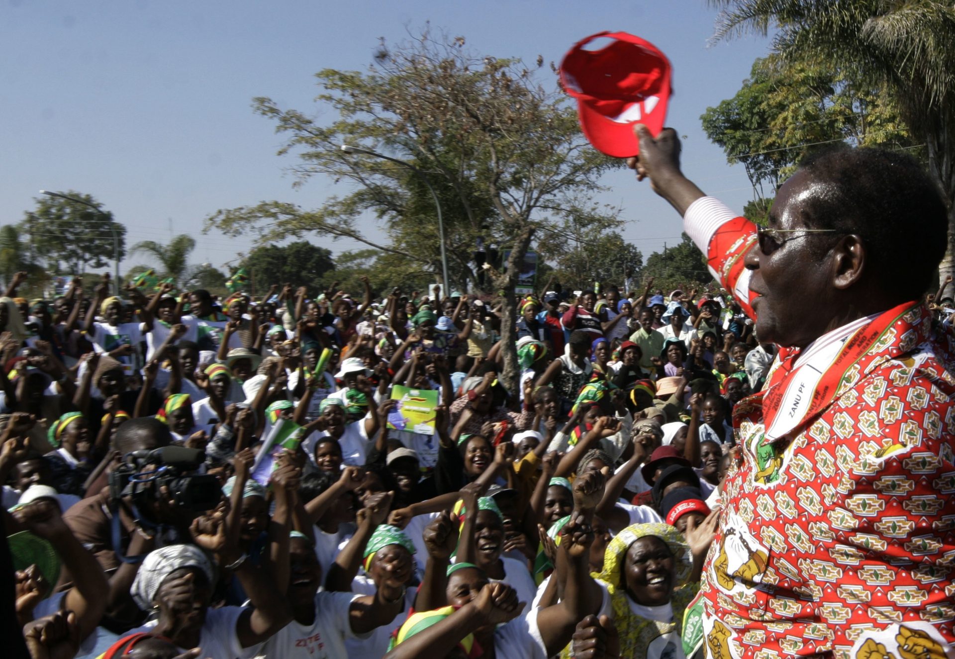 FILE PHOTO: In this Thursday, June 26, 2008 file photo, Zimbabwe's President Robert Mugabe, right, greets the crowd at his final rally in Chitungwiza, Zimbabwe.