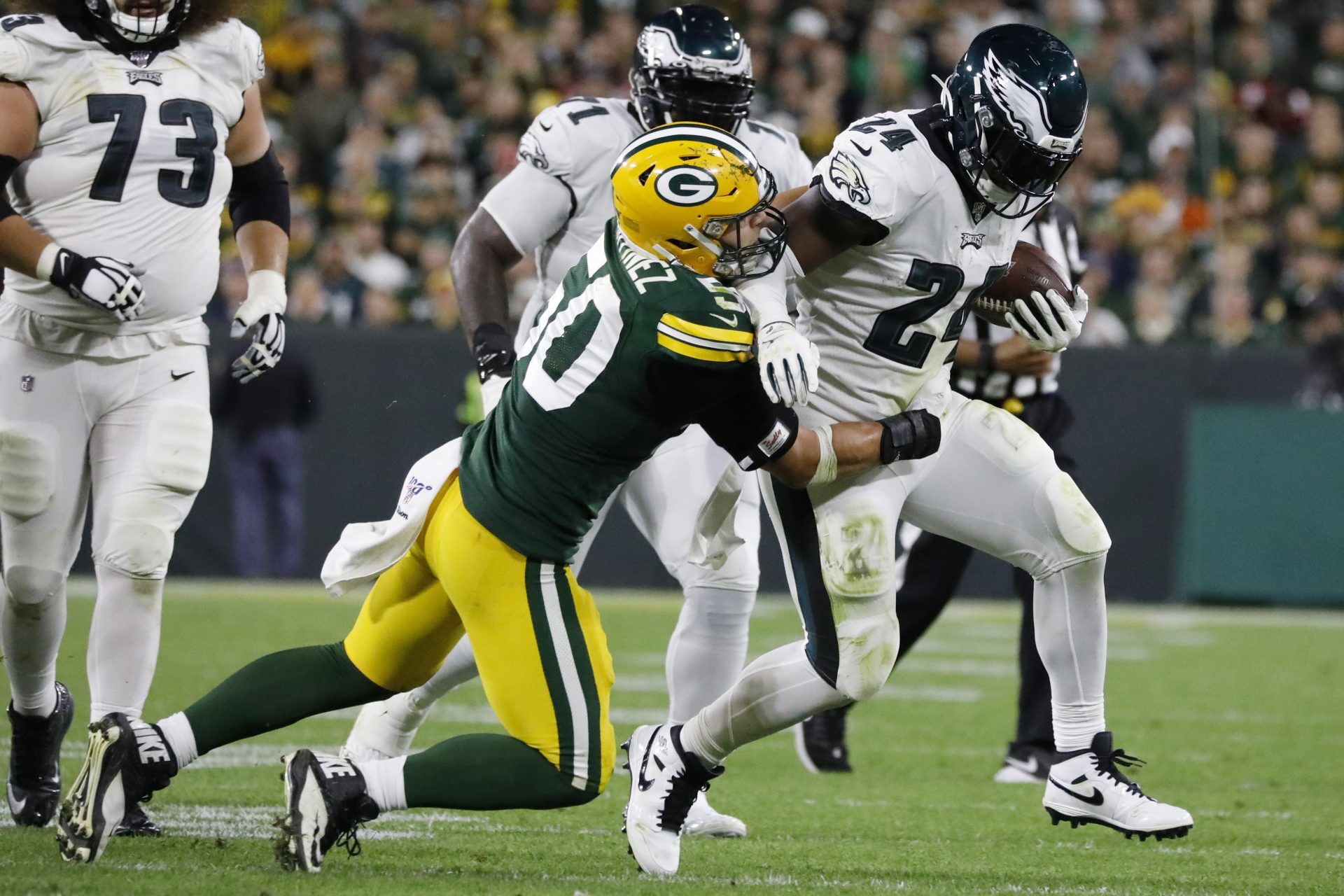 Philadelphia Eagles running back Jordan Howard runs after making a catch and breaks the tackle of Green Bay Packers inside linebacker Blake Martinez during the second half of an NFL football game Thursday, Sept. 26, 2019, in Green Bay, Wis.