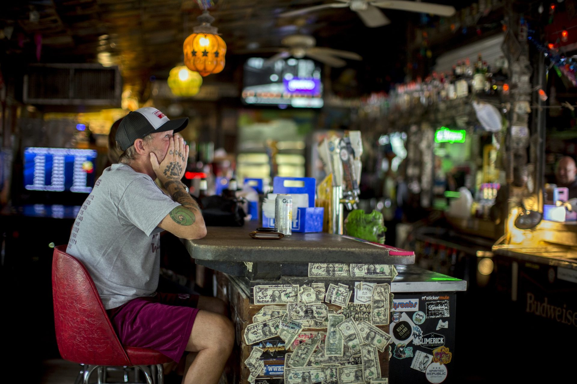 Andrew Parker watches the latest on Hurricane Dorian from the bar at Huc-A-Poos pizza restaurant, Wednesday, Sept. 4, 2019, in Tybee Island, Ga. Parker said he's been through eight hurricanes in his lifetime as a resident of Tybee. And like the others Parker said he plans on riding Dorian out at his home on the island.