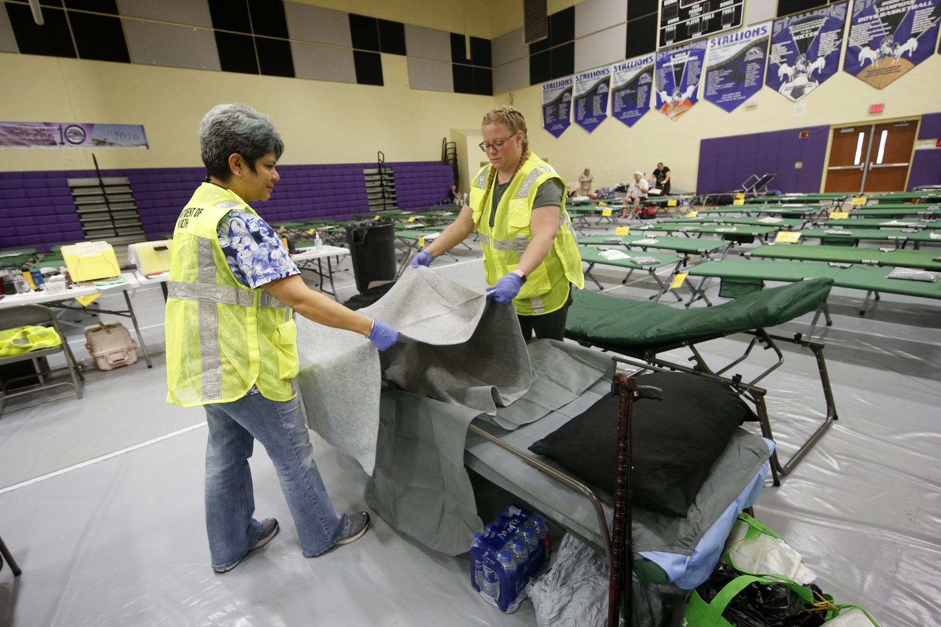 Florida Department of Health staffers set up beds at an evacuation shelter for people with special needs, in preparation for Hurricane Dorian, at Dr. David L. Anderson Middle School in Stuart, Fla., Sunday, Sept. 1, 2019. Some coastal areas are under a mandatory evacuation since the path of the storm is still uncertain. 