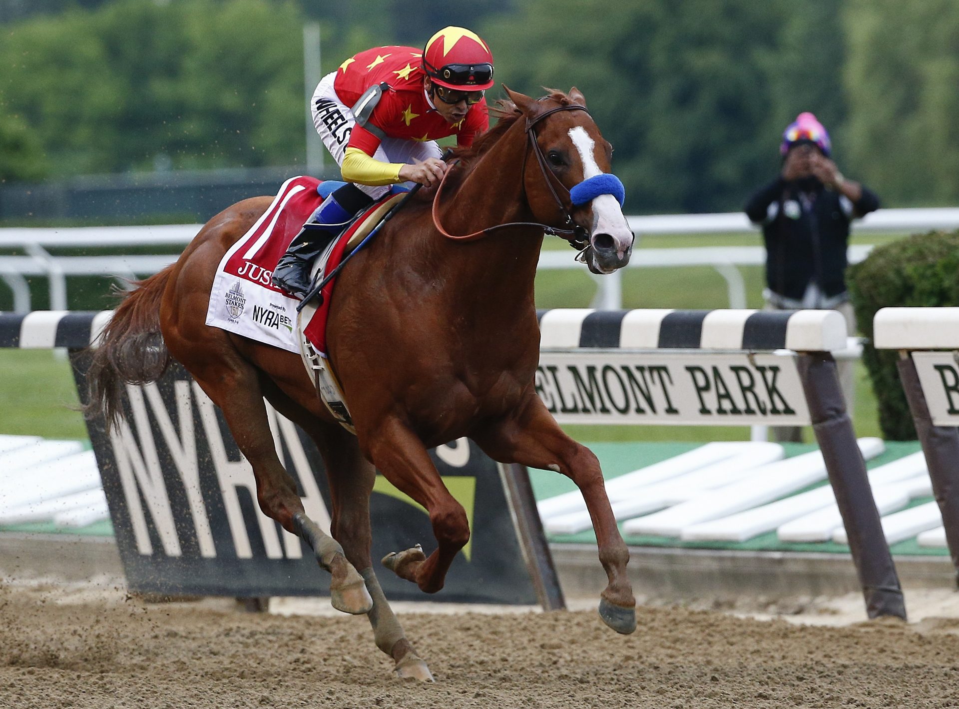 Justify (1), with jockey Mike Smith up, crosses the finish line to win the 150th running of the Belmont Stakes horse race and the Triple Crown, Saturday, June 9, 2018, in Elmont, N.Y.