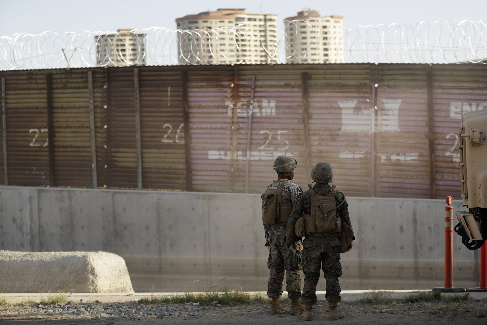FILE PHOTO: Marines look on during work to fortify the border structure that separates Tijuana, Mexico, behind, and San Diego, near the San Ysidro Port of Entry, Friday, Nov. 9, 2018, in San Diego.