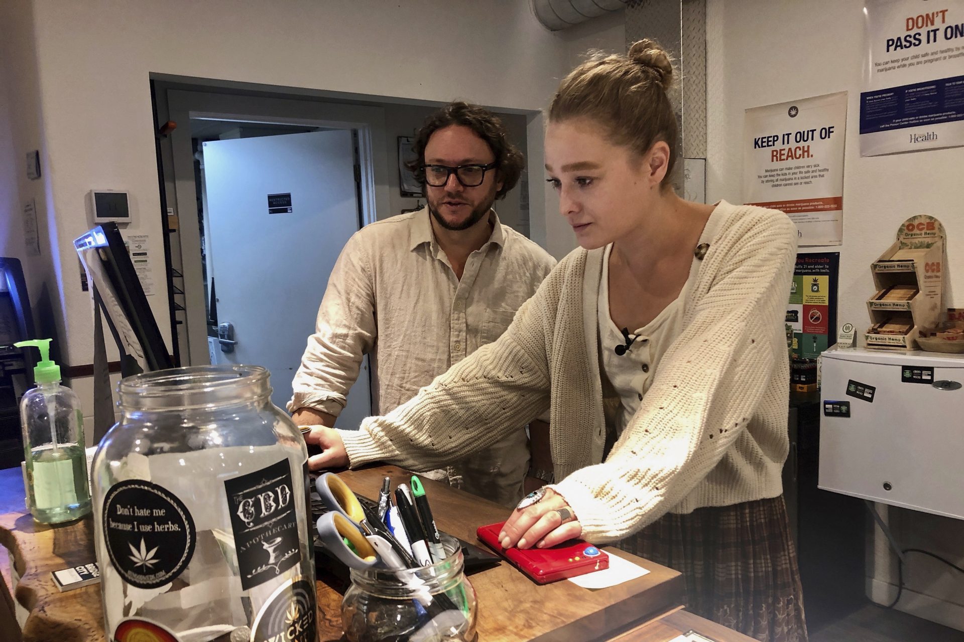 In this photo taken Sept. 20, 2019, David Alport, owner of the Bridge City Collective marijuana dispensary in Portland, Ore., goes over sales numbers with the store's general manager Cameron Moore. The company has seen a 31% decrease in its sales of vaping products in the past two weeks. “It’s having an impact on how consumers are behaving,” said Alport. “People are concerned, and we’re concerned.”