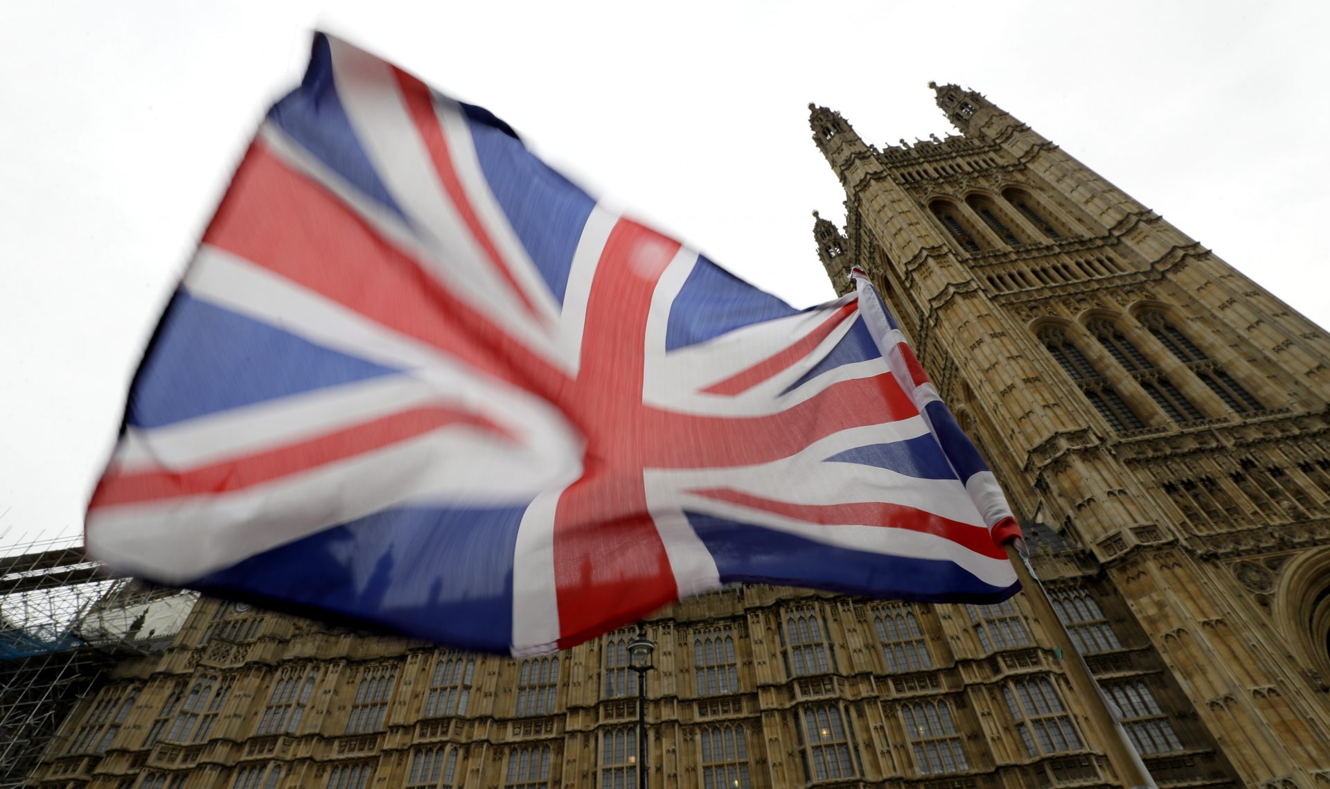 A Union flag flies in front of Parliament in London, Friday, Oct. 25, 2019. Politicians in Britain and the European Union seem to be looking to each other to break the Brexit deadlock.