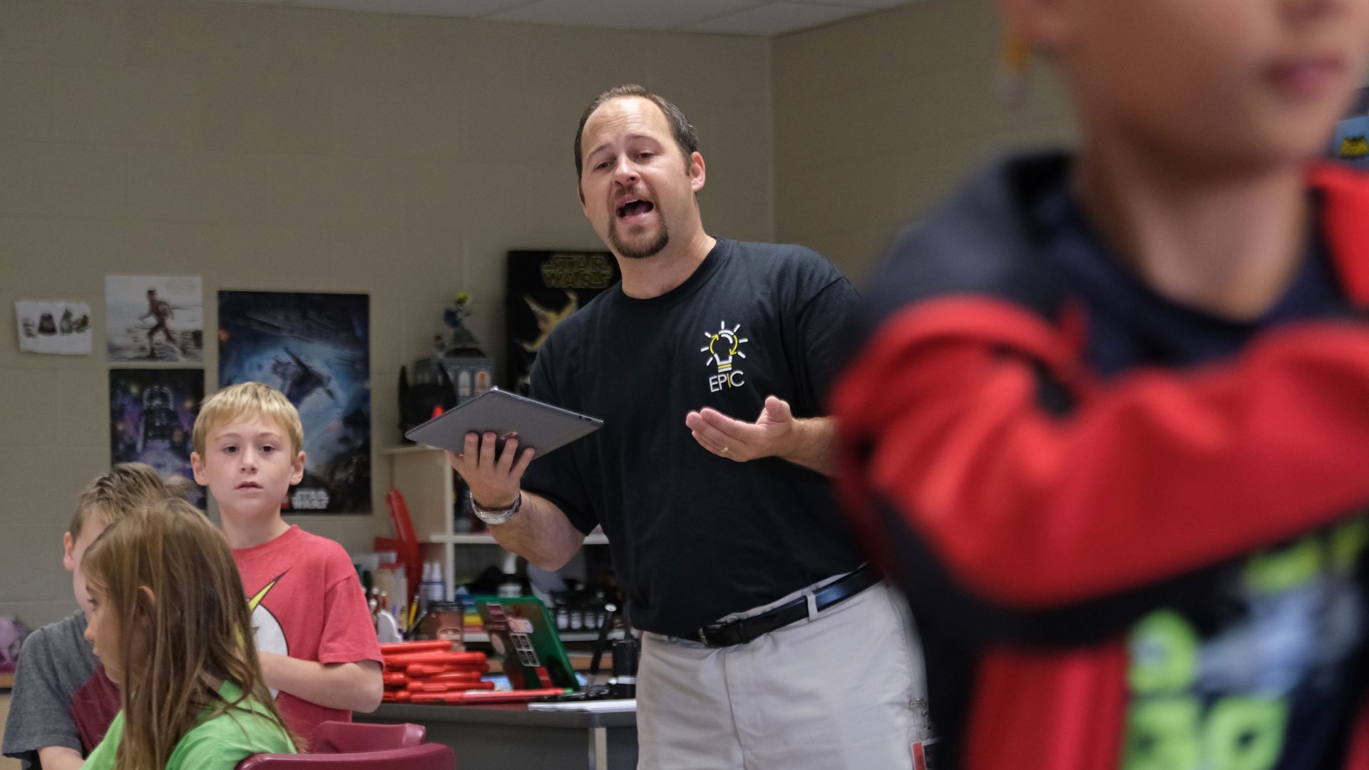 Discovery teacher Matt Derr instructs students as they work with a tornado simulation augmented reality program on smartphones Sept. 26, 2019, at Whitfield Elementary School in Spring Township, Berks County.