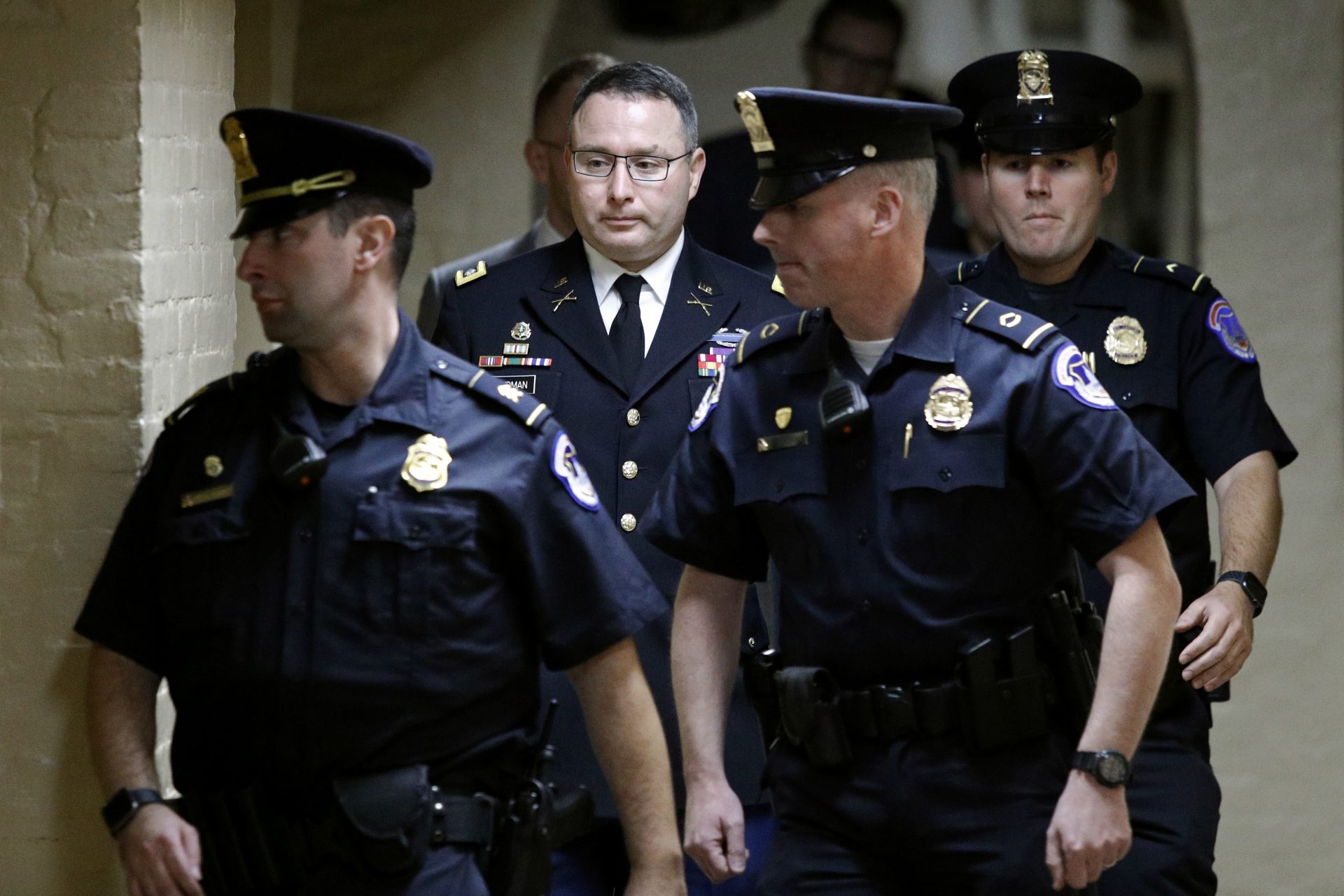Army Lt. Col. Alexander Vindman, second from left, a military officer at the National Security Council, departs a closed door meeting after testifying as part of the House impeachment inquiry into President Donald Trump, Tuesday, Oct. 29, 2019, on Capitol Hill in Washington.