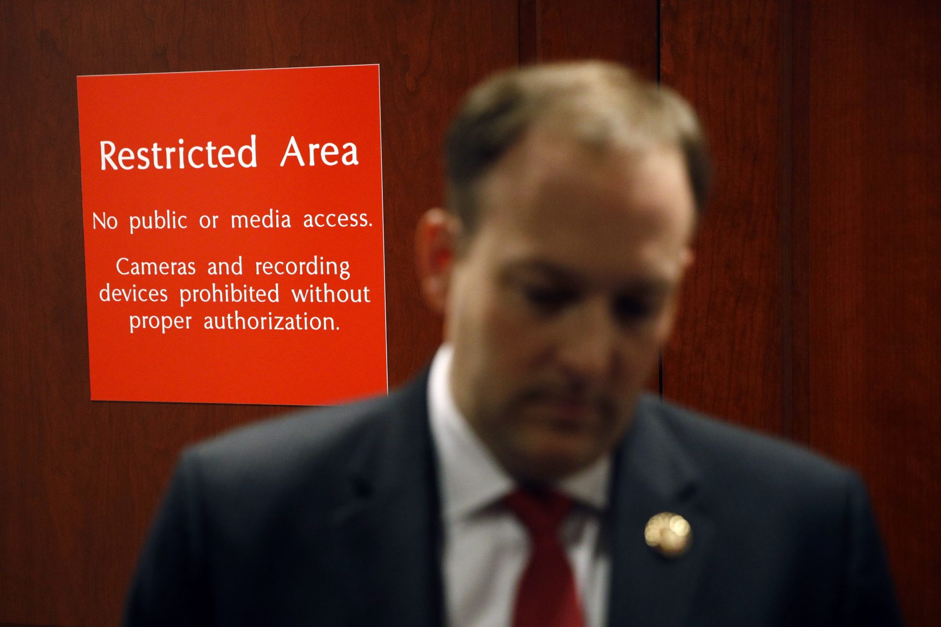 A sign marks a door to a secure area behind Rep. Lee Zeldin, R-N.Y., as he speaks with members of the media after Deputy Assistant Secretary of Defense Laura Cooper arrived for a closed door meeting to testify as part of the House impeachment inquiry into President Donald Trump, Wednesday, Oct. 23, 2019, in Washington.