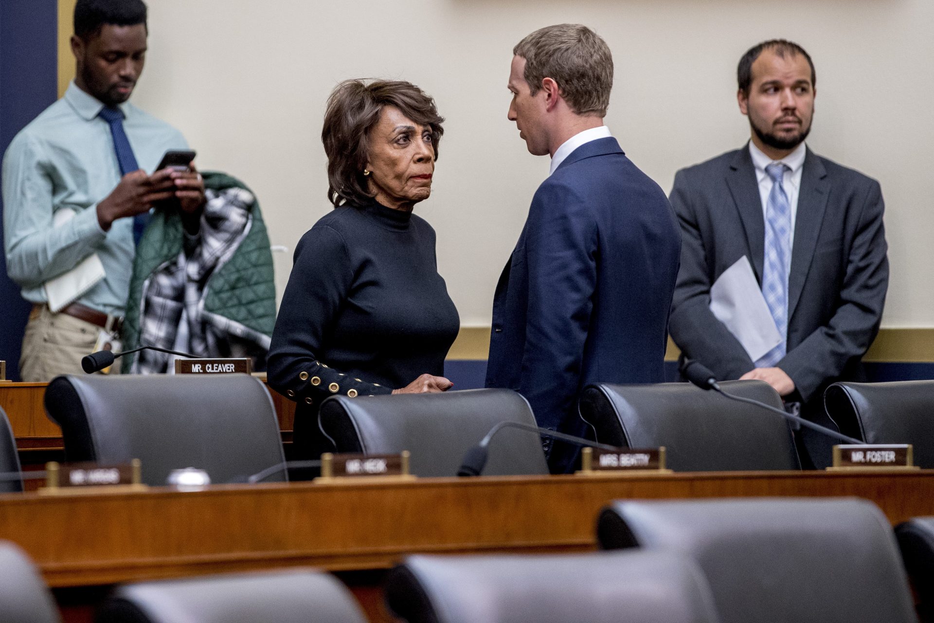 Chairwoman Rep. Maxine Waters, D-Calif., center left, speaks with Facebook CEO Mark Zuckerberg, center right, after he testifies before a House Financial Services Committee hearing on Capitol Hill in Washington, Wednesday, Oct. 23, 2019, on Facebook's impact on the financial services and housing sectors.