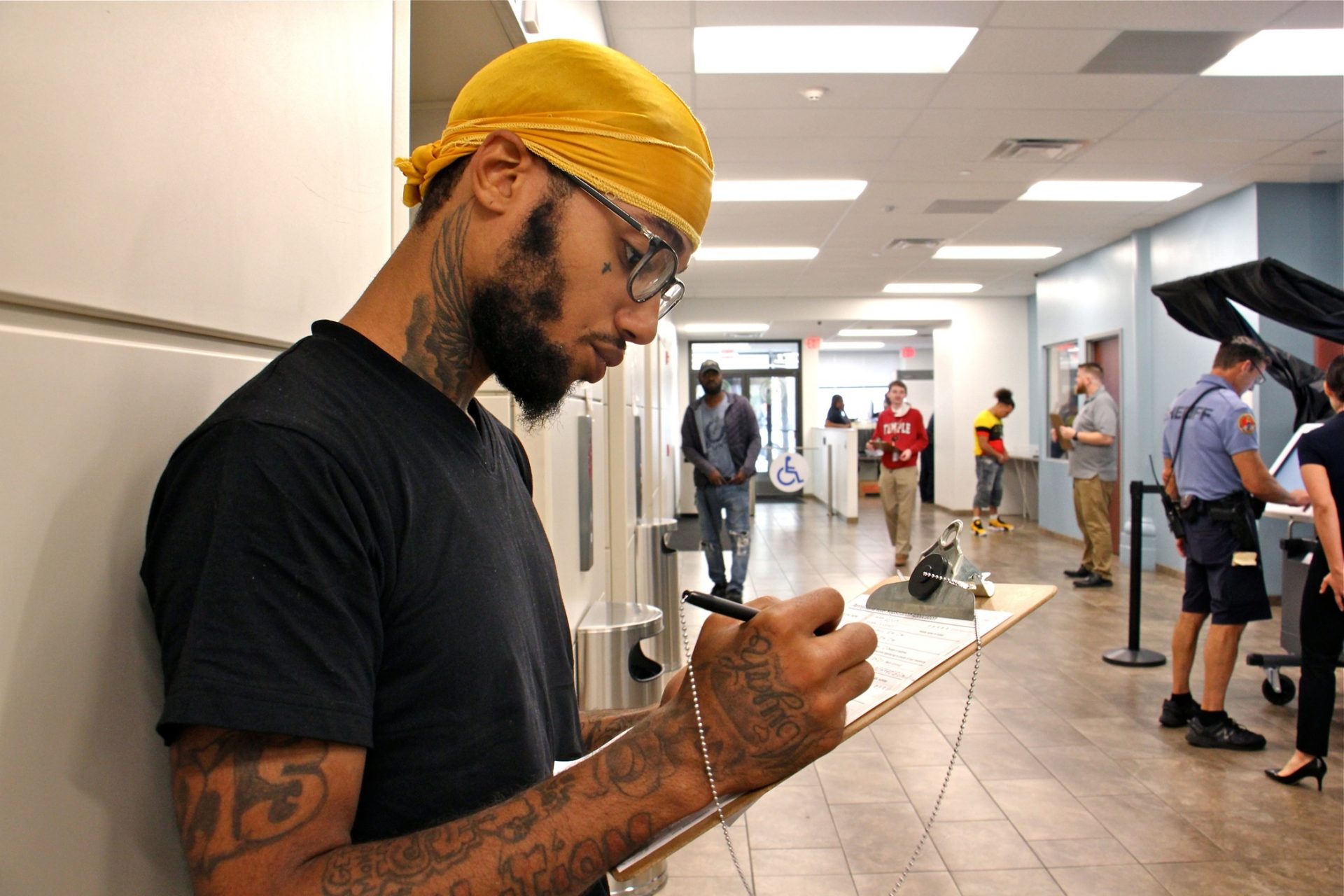 Cristofer Rojas, 21, registers to vote in the lobby of the Adult Probation and Parole Office at 7th and Market streets, where a voter registration event was held to make parolees aware that their convictions do not prevent them from voting in Pennsylvania.