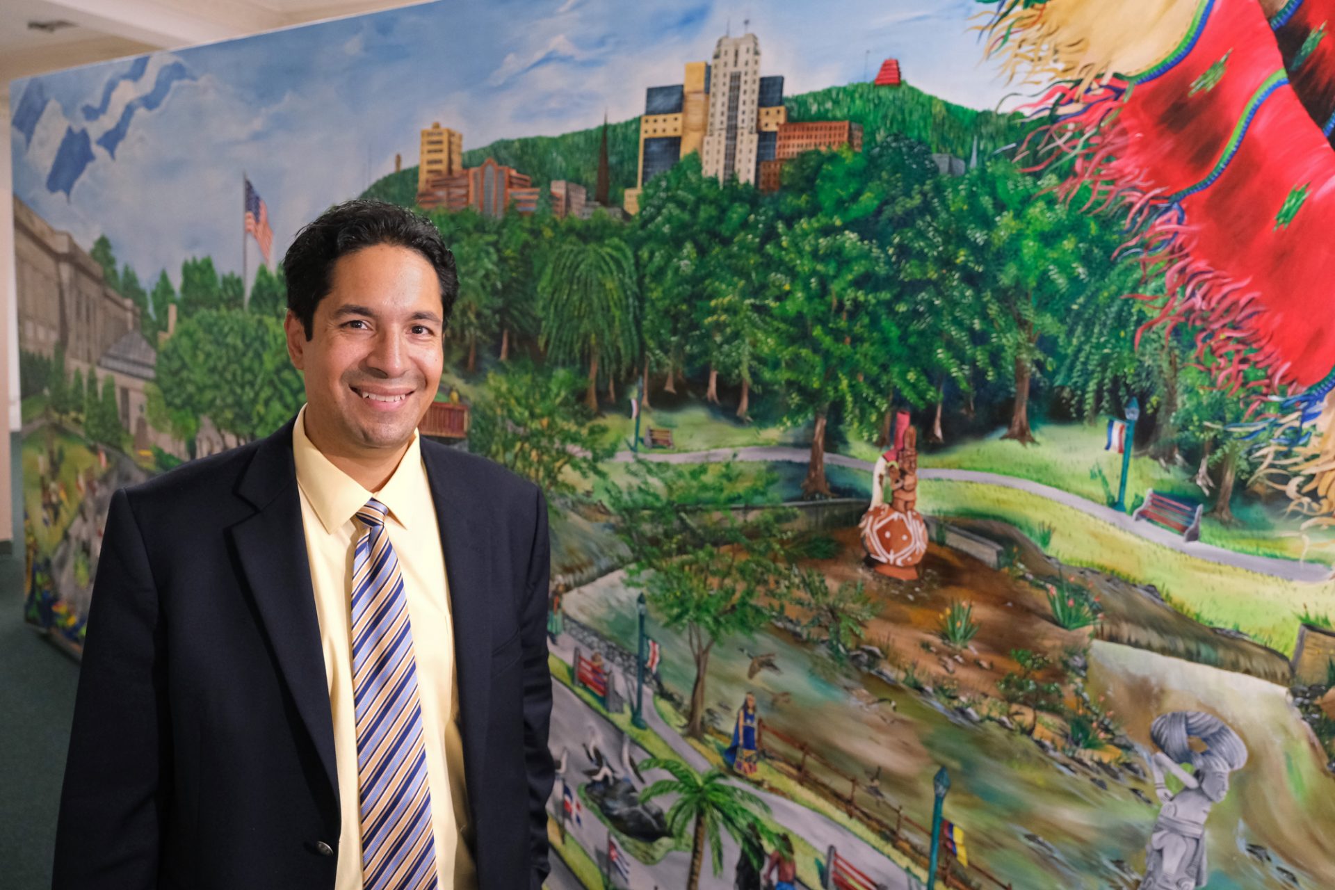 Centro Hispano Executive Director Mike Toledo stands near a mural of Reading on Oct. 31, 2019, while at the center on 5th Street in Reading, Pennsylvania.