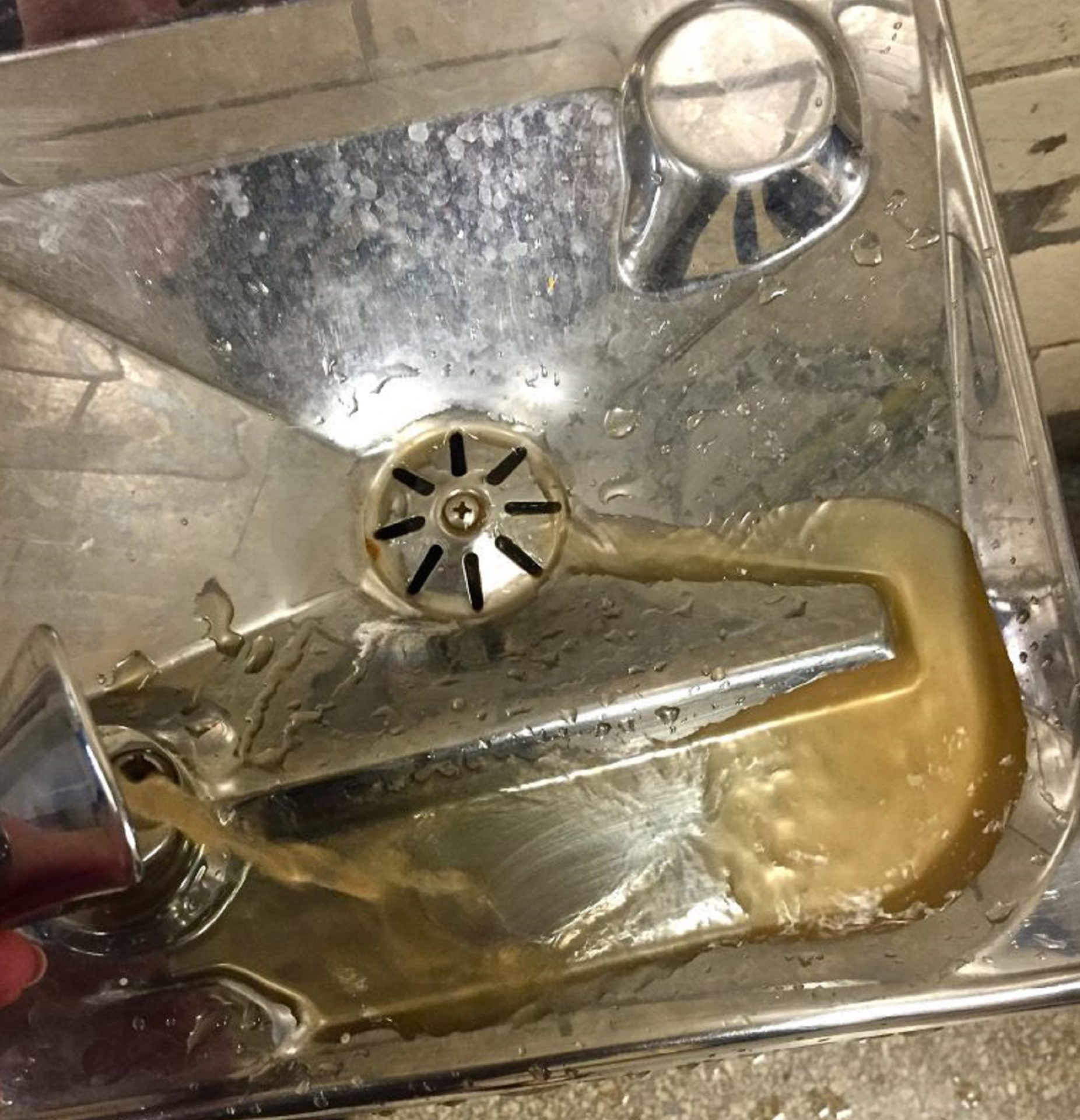 A photo taken by a former teacher at Frederick Douglass Mastery Charter School shows brown water flowing from a drinking fountain at the school in June of 2016. 