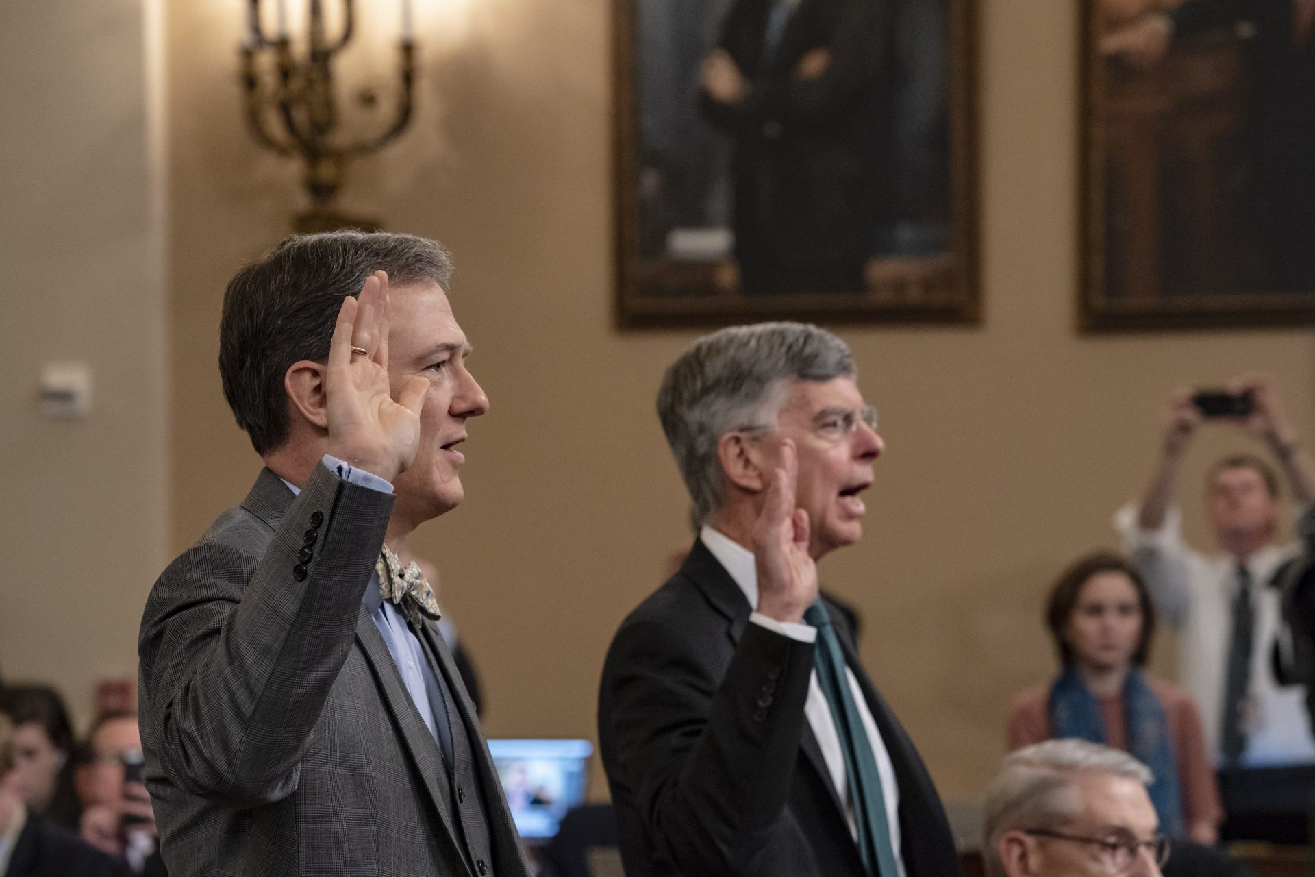 Career Foreign Service officer George Kent, left, and top U.S. diplomat in Ukraine William Taylor, right, are sworn in to testify before the House Intelligence Committee on Capitol Hill in Washington, Wednesday, Nov. 13, 2019, during the first public impeachment hearings on President Donald Trump's efforts to tie U.S. aid for Ukraine to investigations of his political opponents.