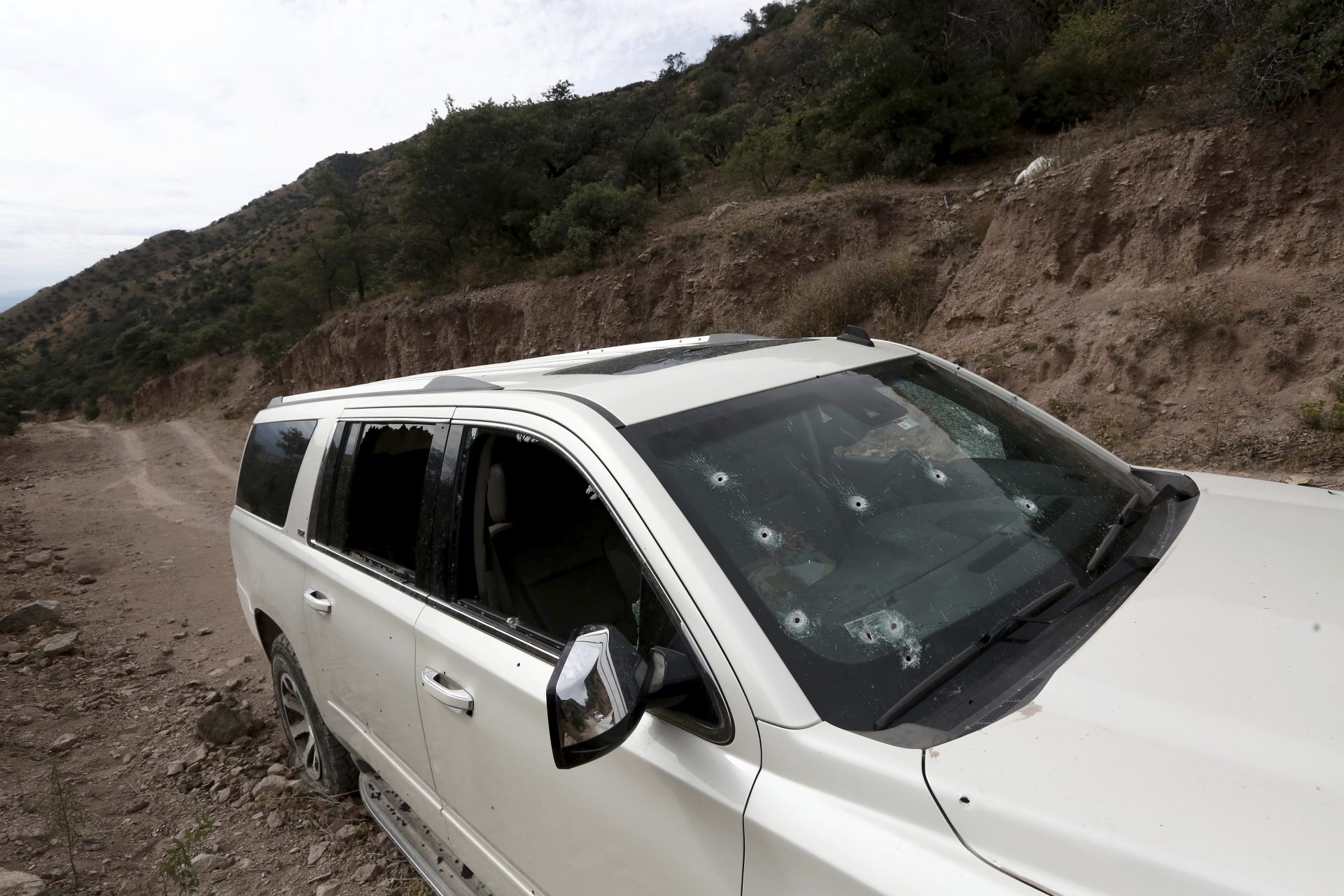 A bullet-riddled vehicle that members of LeBaron family were traveling in sits parked on a dirt road near Bavispe, at the Sonora-Chihuahua border, Mexico, Wednesday, Nov 6, 2019. Three women and six of their children, related to the extended LeBaron family, were gunned down in an attack while traveling along Mexico's Chihuahua and Sonora state border on Monday.