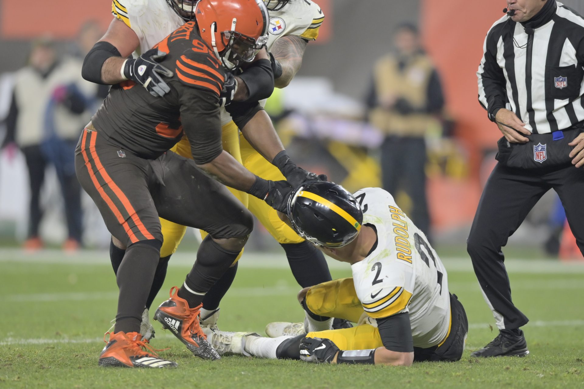 Cleveland Browns defensive end Myles Garrett (95) pulls the helmet off Pittsburgh Steelers quarterback Mason Rudolph (2) in the fourth quarter of an NFL football game, Thursday, Nov. 14, 2019, in Cleveland. The Browns won 21-7.