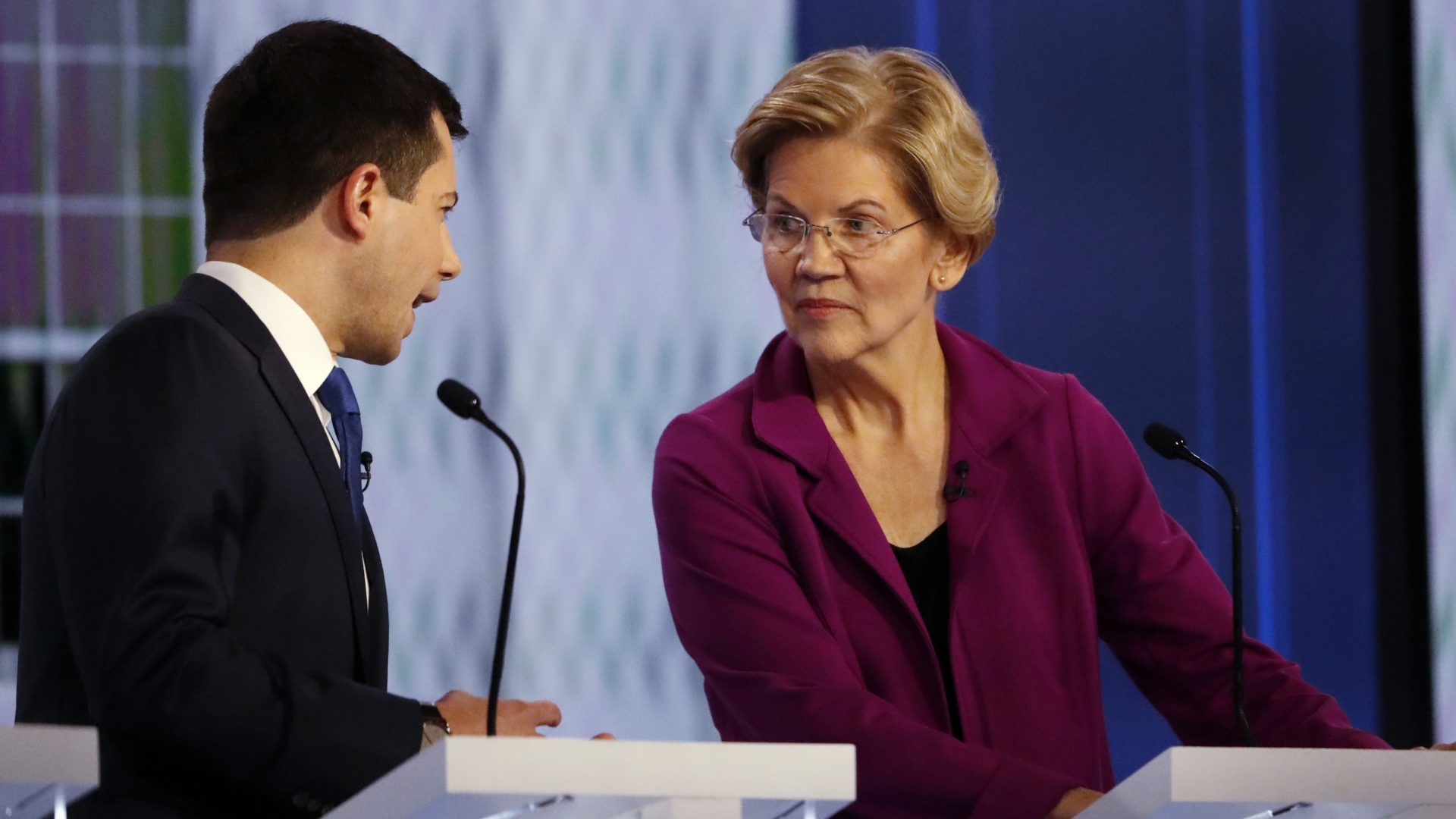 Democratic presidential candidate South Bend, Ind., Mayor Pete Buttigieg speaks with Sen. Elizabeth Warren, D-Mass., during a commercial break in the November Democratic presidential primary debate in Atlanta. They are back onstage Thursday in Los Angeles.