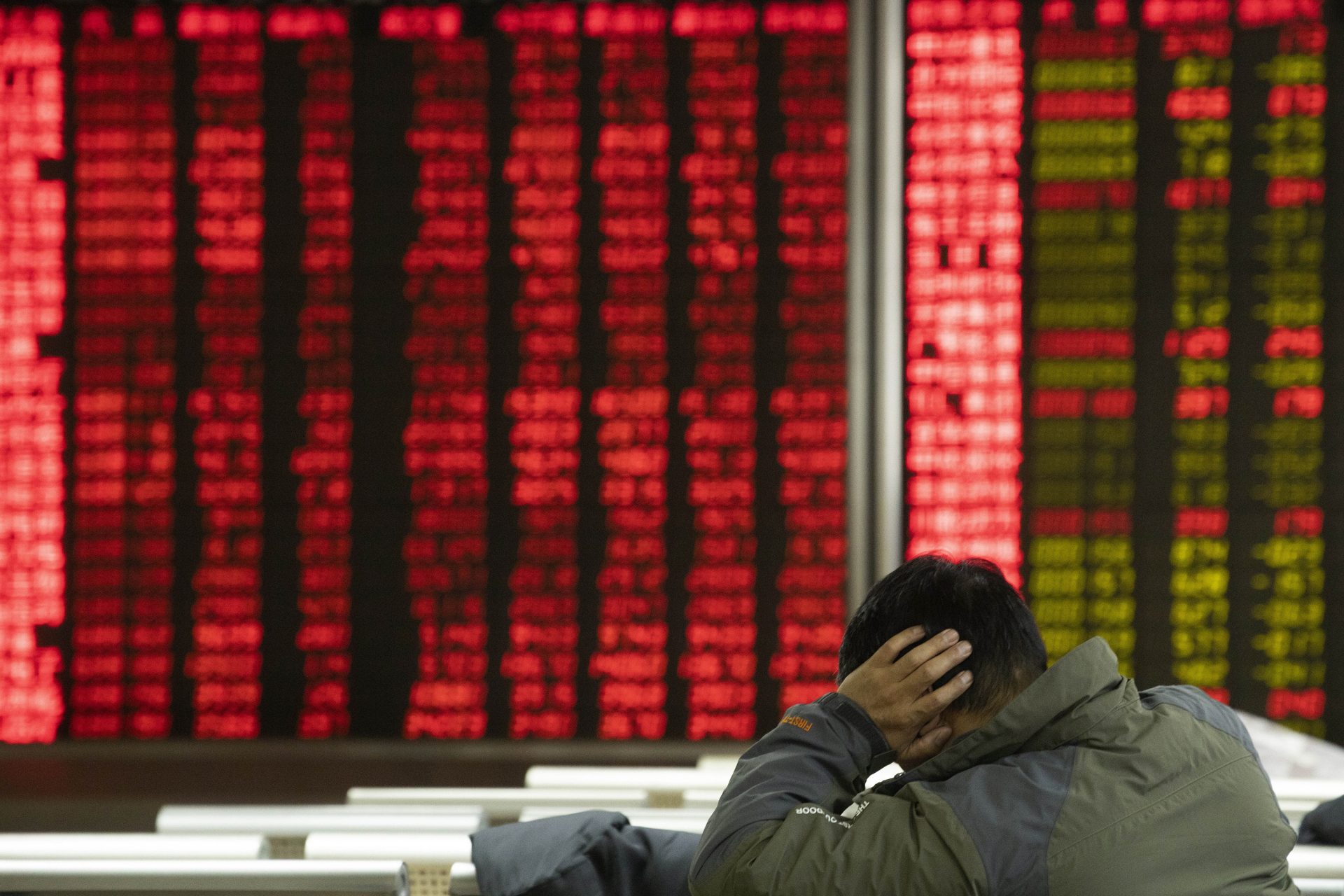 In this Thursday, Dec. 12, 2019, photo, an investor monitors stock prices at a brokerage in Beijing. Shares likewise jumped Friday, Dec. 13, 2019 in Asia following fresh all-time highs overnight on Wall Street spurred by optimism that the U.S. and China are close to reaching a deal to end their costly trade war.