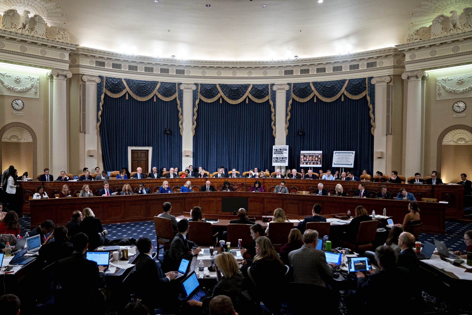 Committee members work into the late evening during a House Judiciary Committee markup of the articles of impeachment against President Donald Trump, on Capitol Hill in Washington, Thursday, Dec. 12, 2019.