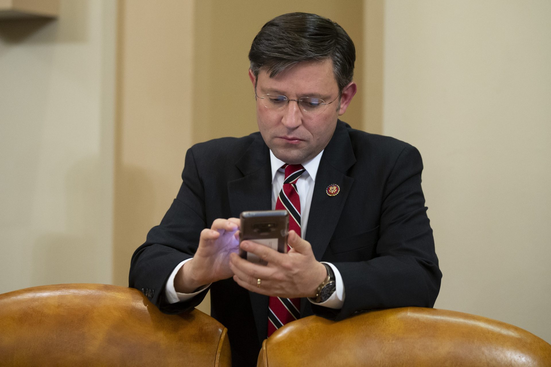 Rep. Mike Johnson, R-La., looks at a phone during a break of the House Judiciary Committee markup of the articles of impeachment against President Donald Trump, on Capitol Hill, Thursday, Dec. 12, 2019, in Washington.