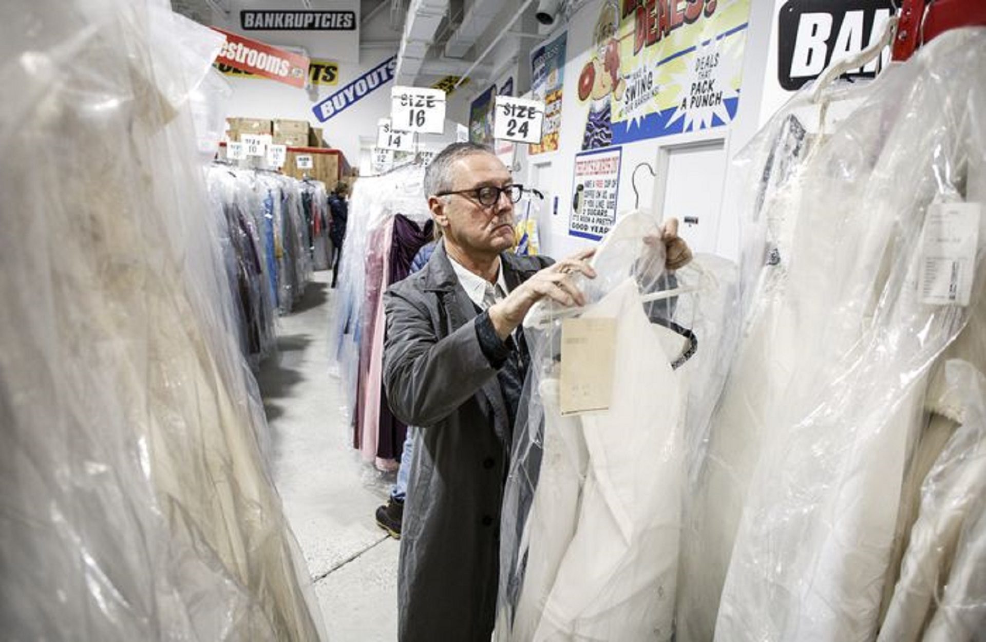 Mark Butler, Ollie's president and CEO, looks at the dresses being offered in the sale. Ollie's Bargain Outlet purchased 11,000 wedding dresses and 18,000 formal, prom and bridesmaids dresses from a wedding distributor. For 10 days, the dresses are available at two Harrisburg-area stores. February 7, 2019.