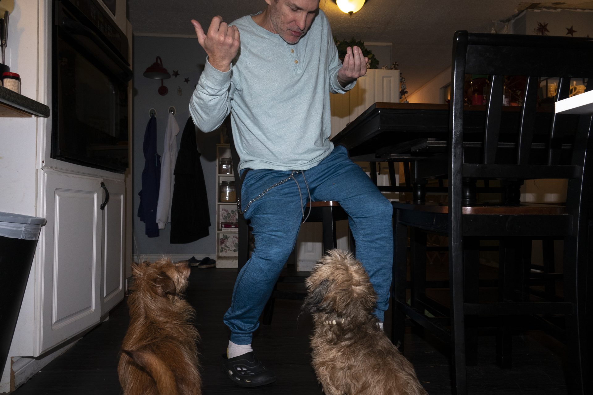 Chuck at home with Donna's two dogs. His injury keeps him from living on his own, but he dreams of someday buying a motor home for himself and road-tripping across the country.