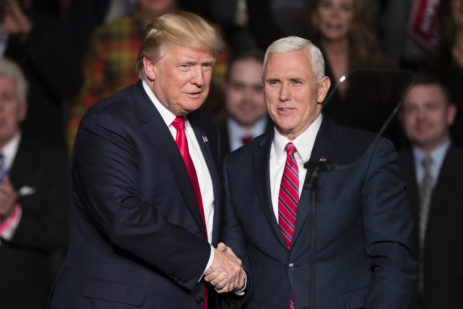 FILE PHOTO: President-elect Donald Trump, left, shakes hands with Vice President-elect Mike Pence during a rally at the Giant Center, Thursday, Dec. 15, 2016, in Hershey.