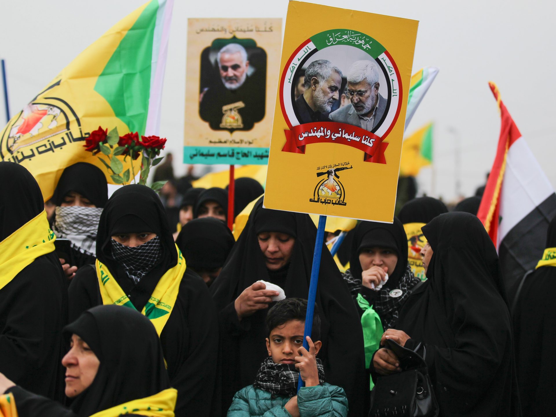 Demonstrators hold aloft portraits of Iraqi paramilitary chief Abu Mahdi al-Muhandis and Iranian military leader Qassem Soleimani during the funeral procession Saturday in Baghdad. The crowd of thousands chanted "Death to America" at times.