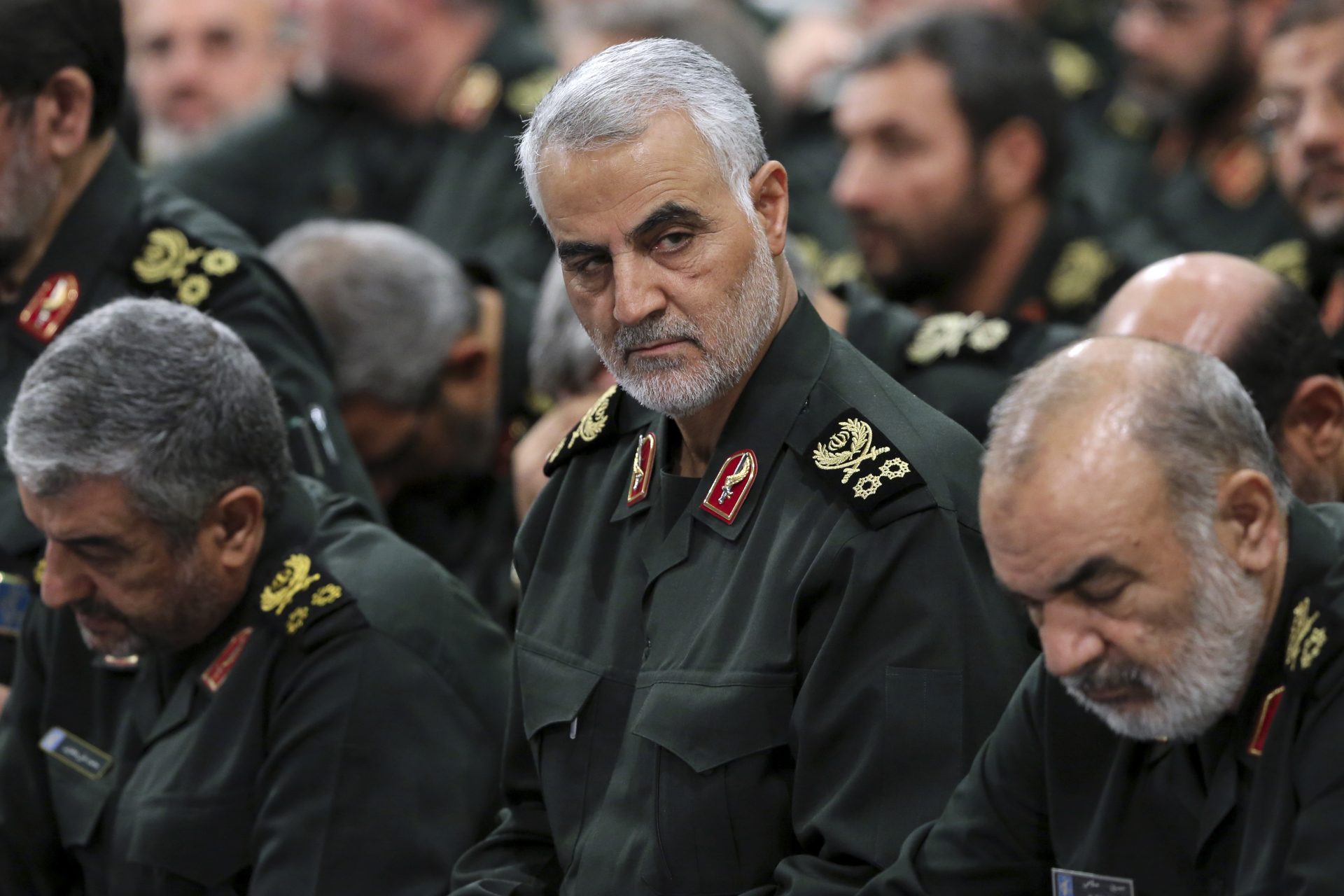 FILE PHOTO: In this Sept. 18, 2016 file photo released by an official website of the office of the Iranian supreme leader, Revolutionary Guard Gen. Qassem Soleimani, center, attends a meeting in Tehran, Iran. The long shadow war between Israel and Iran has burst into the open in recent days, with Israel allegedly striking Iran-linked targets as far away as Iraq and crash-landing two drones in Lebanon. These incidents, along with an air raid in Syria that Israel says thwarted an imminent Iranian drone attack, have raised tensions at a particularly fraught time. Israel said Soleimani masterminded the alleged drone attack.
