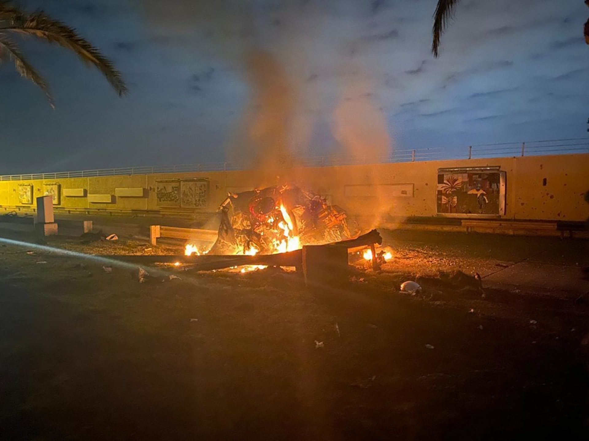 This photo released by the Iraqi Prime Minister Press Office shows a burning vehicle at the Baghdad International Airport following an airstrike in Baghdad, Iraq, early Friday, Jan. 3, 2020. The Pentagon said Thursday that the U.S. military has killed Gen. Qassem Soleimani, the head of Iran's elite Quds Force, at the direction of President Donald Trump.