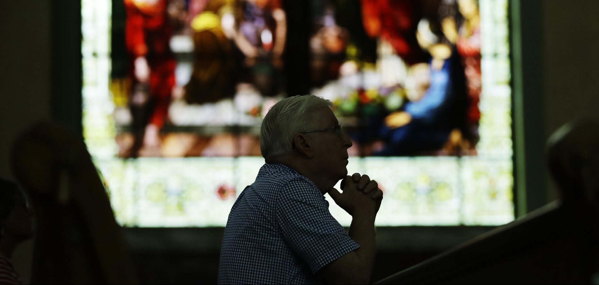 A parishioner prays ahead of a mass celebrated by Bishop Ronald Gainer, of the Harrisburg Diocese, at the Cathedral Church of Saint Patrick in Harrisburg, Pa., Friday, Aug. 17, 2018.