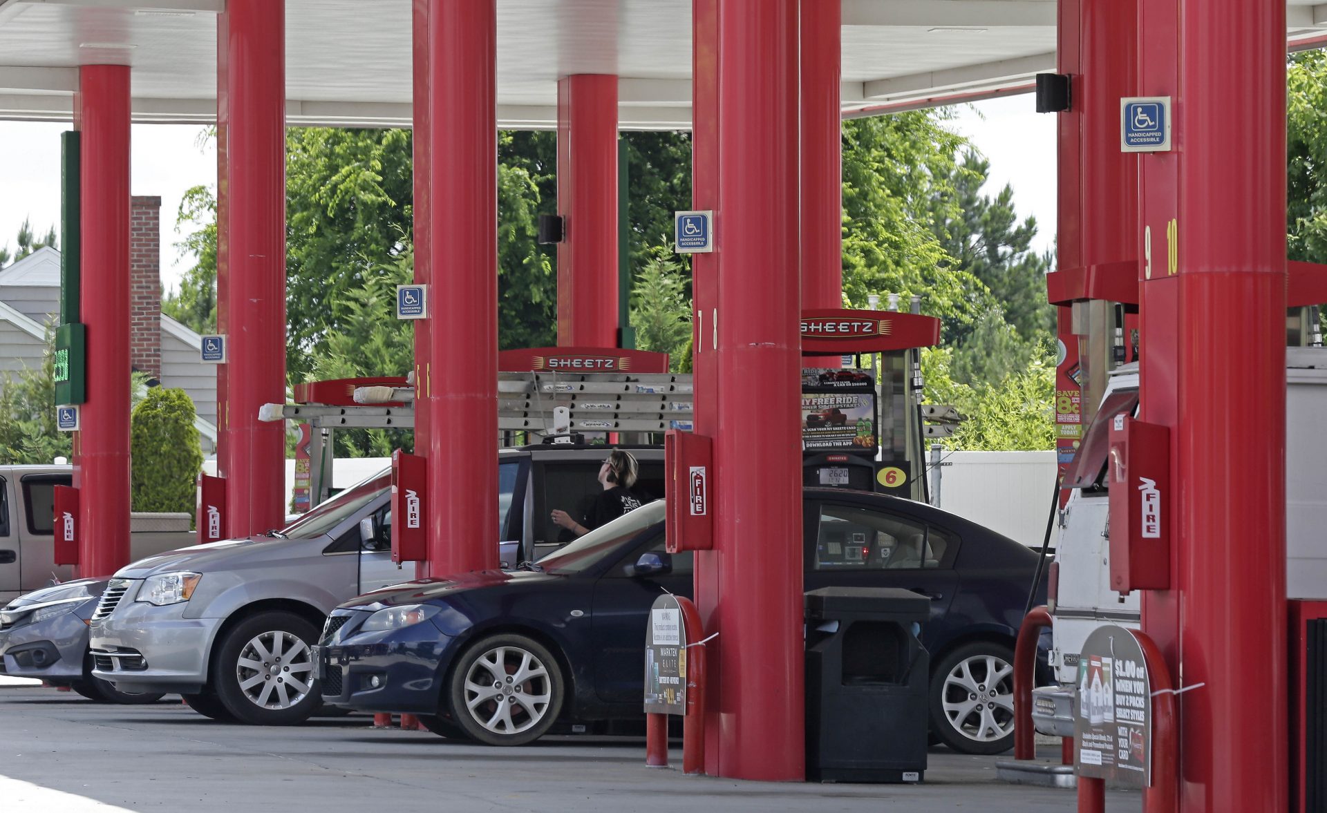 In this photo taken Thursday, June 14, 2018 cars are fueled at Sheetz along the Interstate 85 and 40 corridor near Burlington, N.C.