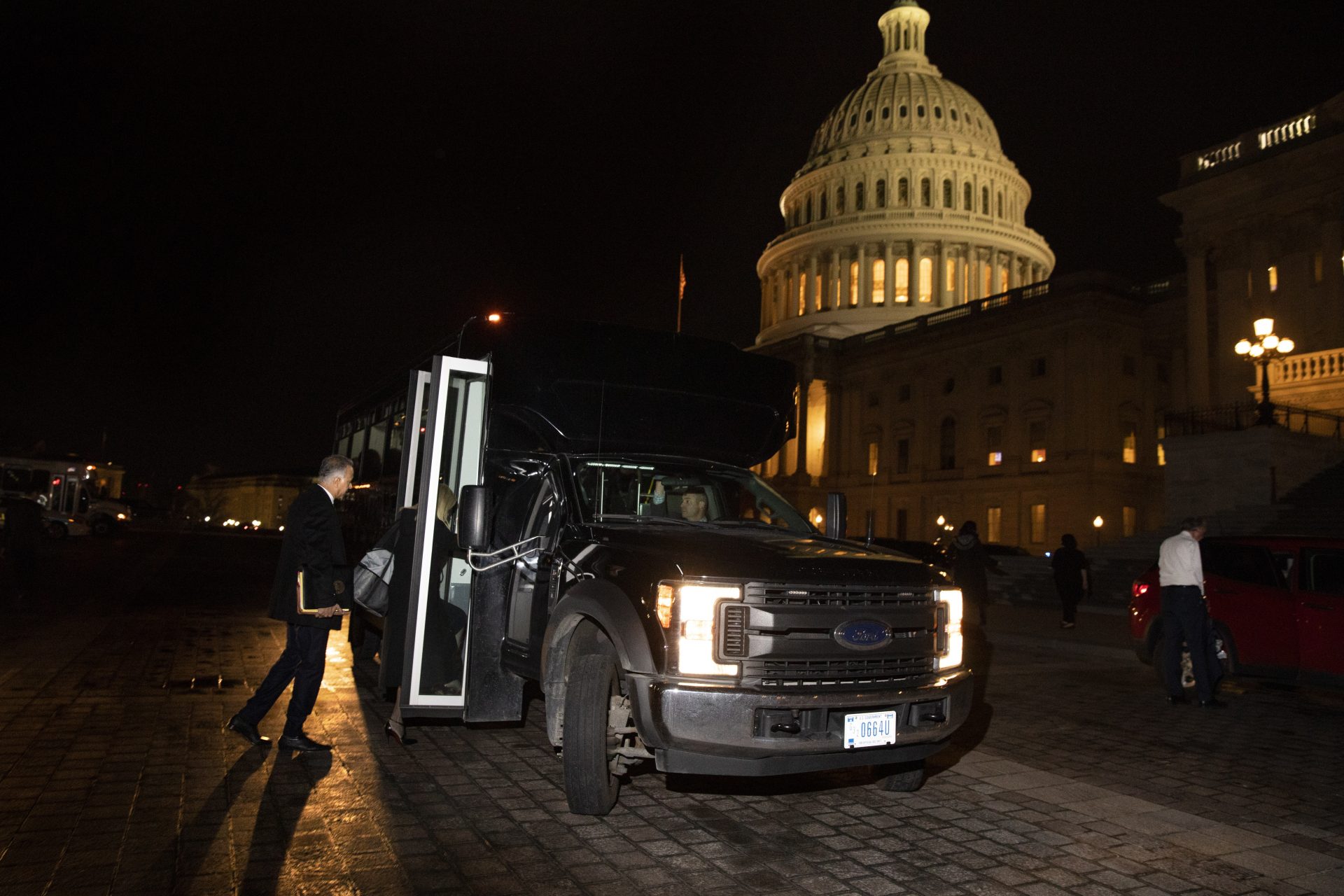 The legal defense team for President Donald Trump is loaded on a bus on Capitol Hill in Washington, Friday, Jan. 31, 2020, as they leave after the Senate voted to not allow witnesses in the impeachment trial of President Donald Trump on charges of abuse of power and obstruction of Congress.