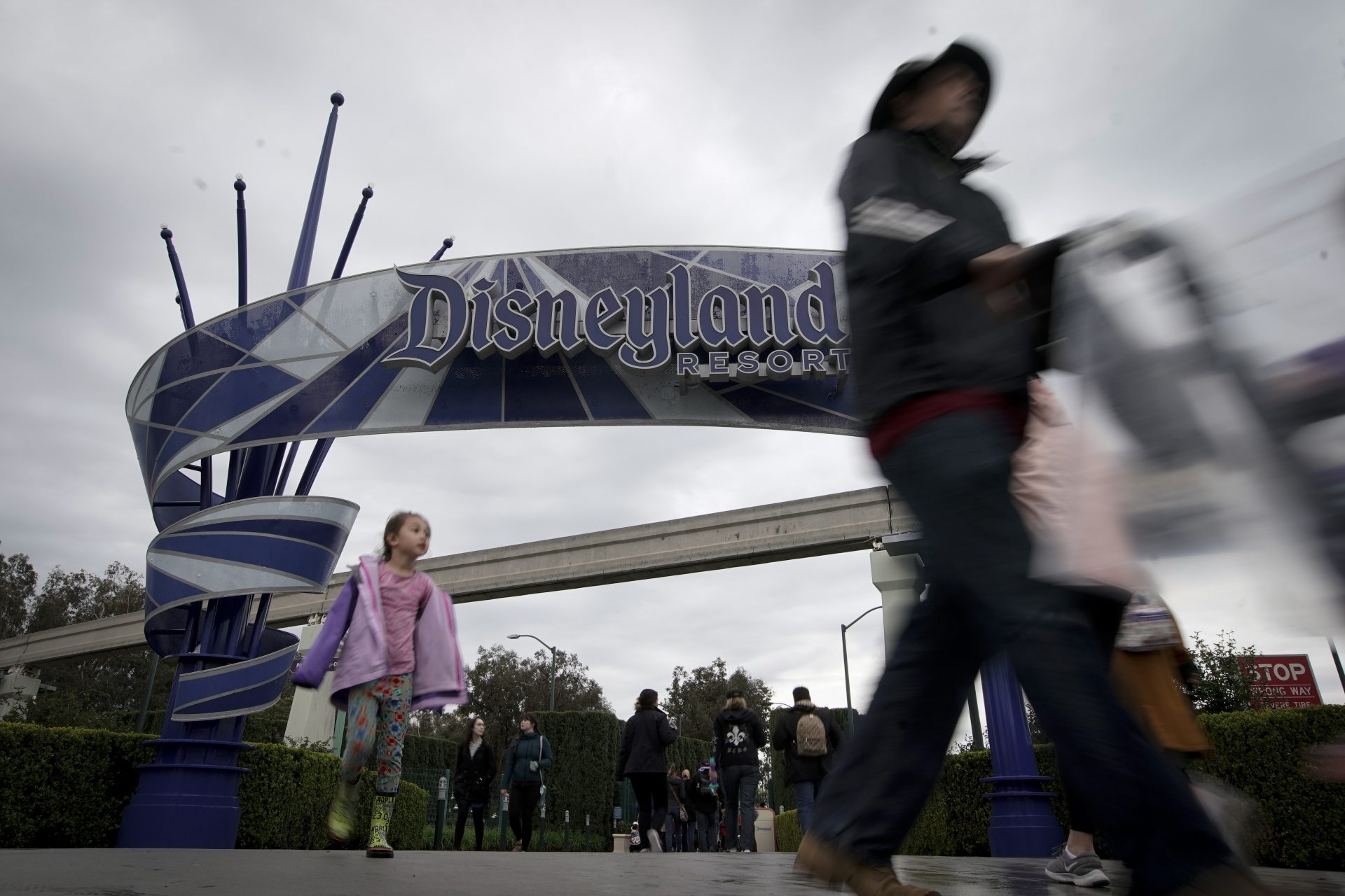 Visitors to Disneyland make their way in and out of the parks Thursday, March 12, 2020, in Anaheim, Calif. Walt Disney Co. is shutting both its Disneyland and California Adventure amusements parks in Anaheim on Saturday, for the rest of the month. (