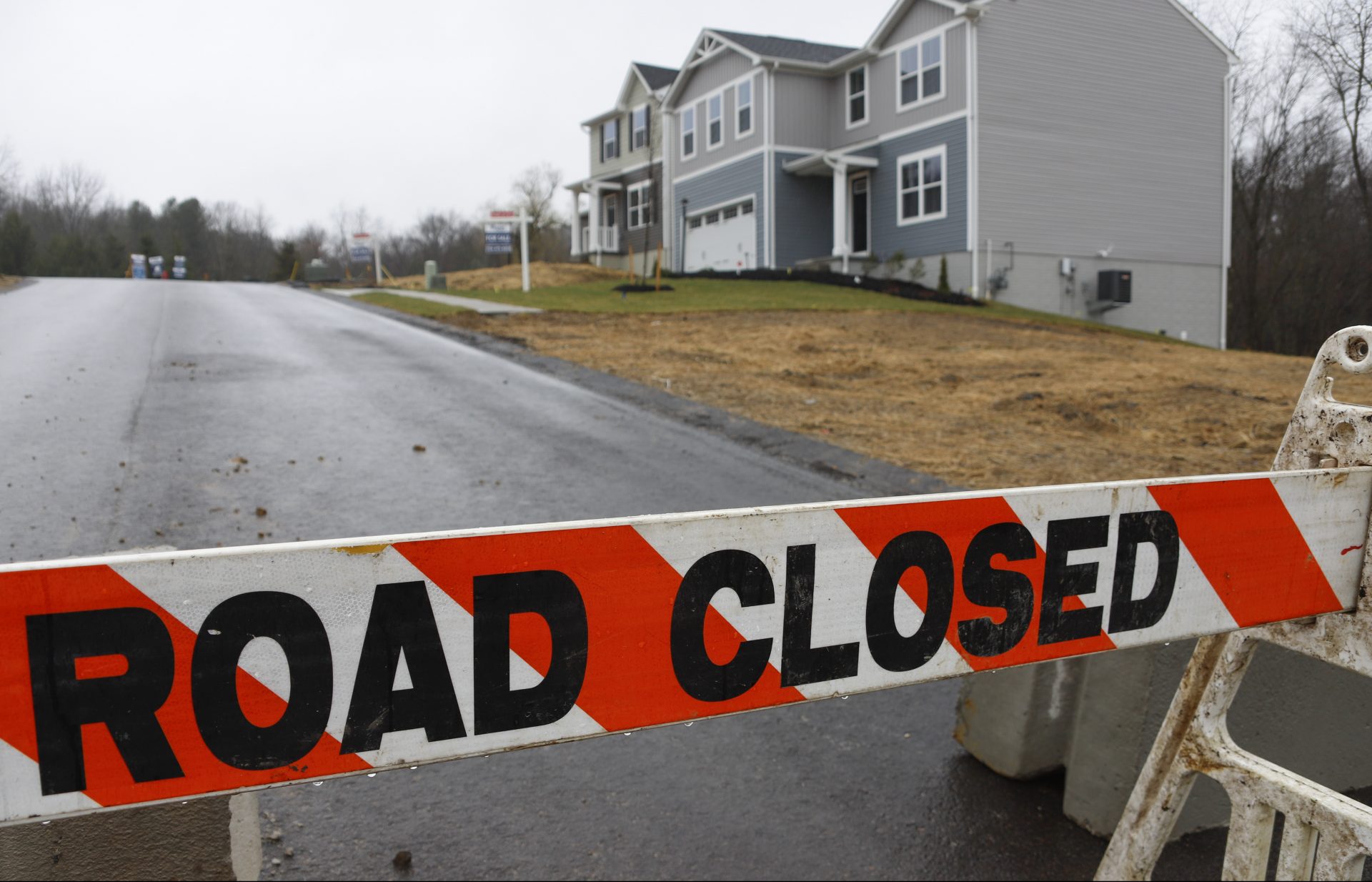 A barricade blocks the road to a new home construction site in Zelienople, Pa., as enforcement of Pennsylvania Gov. Tom Wolf's order to close non-essential businesses, including building and highway construction, was set to begin Monday, March 23, 2020 in efforts to slow the spread of the Coronavirus.