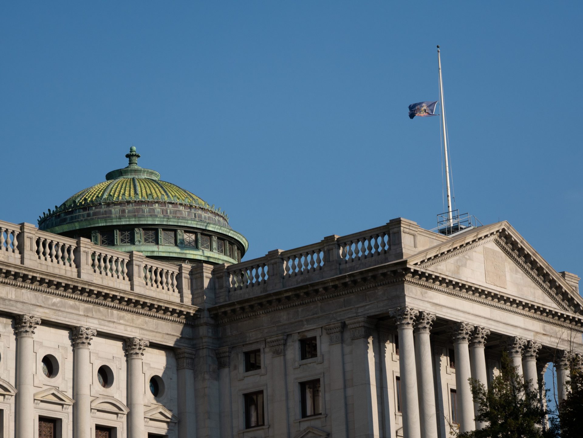 The Pennsylvania state flag flies at half-mast atop the capitol building on Oct. 31, 2018.