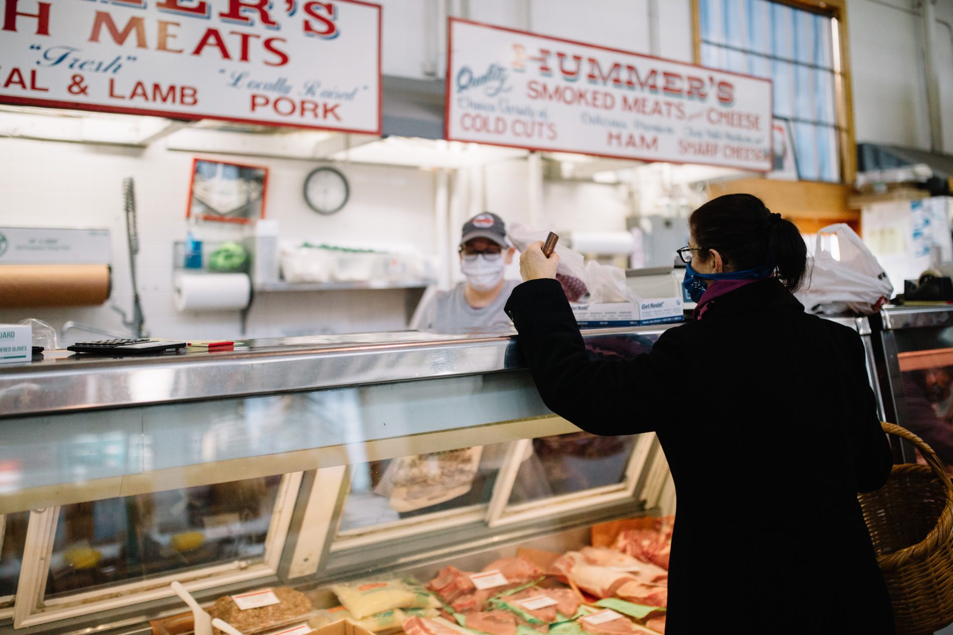 A woman purchases meat at Broad Street Market in Harrisburg on April 10, 2020. The market is much quieter since the coronavirus pandemic effectively shut down the region.