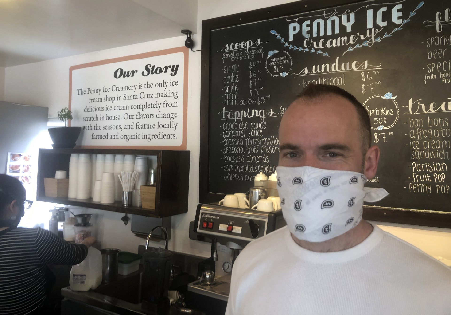 In this April 17, 2020, photo, Zachary Davis poses for a photo at The Penny Ice Creamery in Santa Cruz, Calif. An investigation by The Associated Press hows that many large companies which collectively received tens of millions of dollars in federal loans through the Paycheck Protection Program were at risk of failing even before the coronavirus walloped the economy, while others have acknowledged problems keeping their finances straight and a few have been under investigation by the Securities and Exchange Commission. That big companies and ones with questionable records received such precious financial aid during the chaotic last few weeks frustrates Davis, “We were feeling pretty good about where we were in the world. Now it’s just all turned upside down,” said Davis, who had to lay off 70 workers.