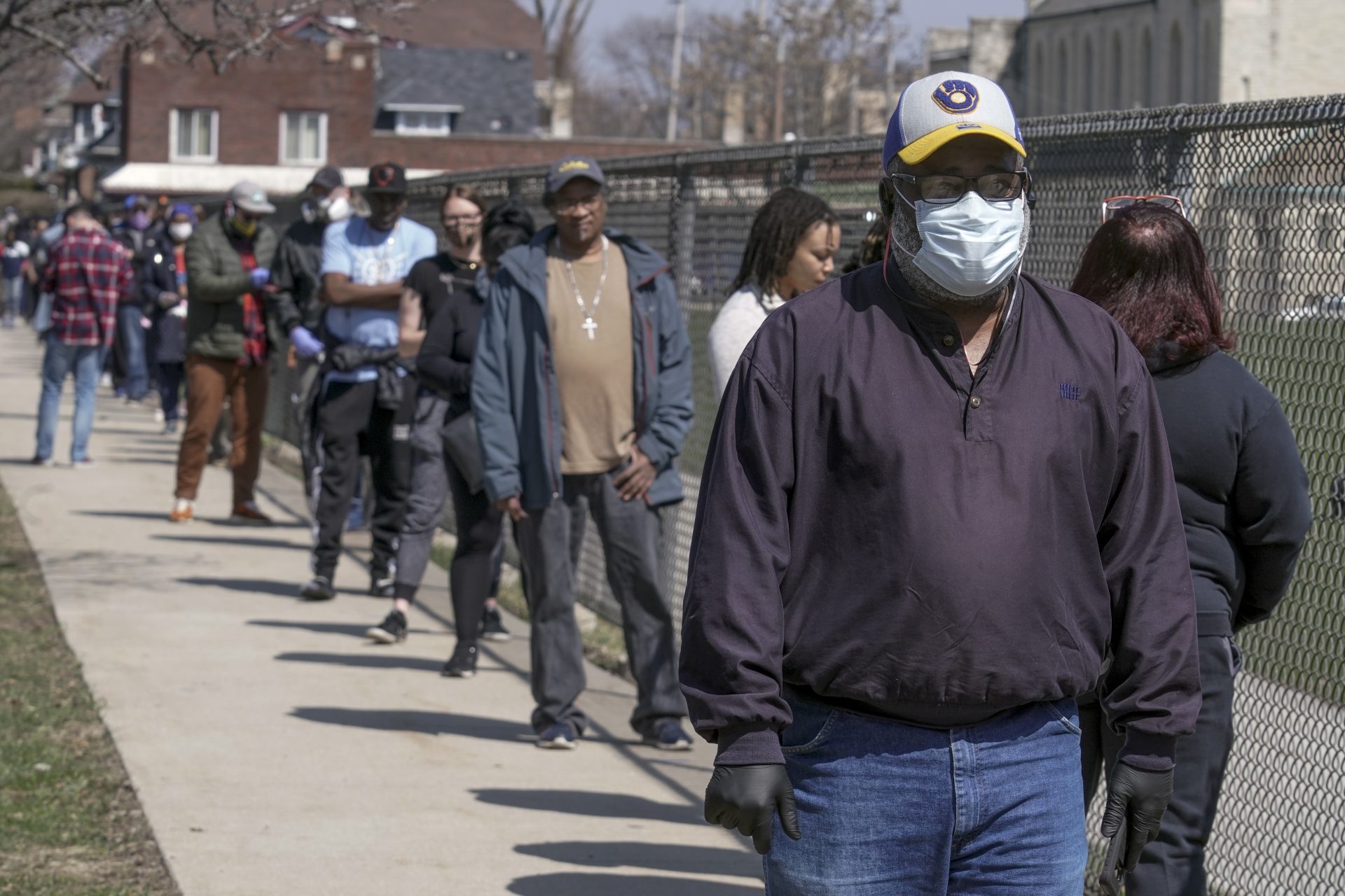 Voters observe social distancing guidelines as they wait in line to cast ballots at Washington High School while ignoring a stay-at-home order over the coronavirus threat to vote in the state's presidential primary election, Tuesday, April 7, 2020, in Milwaukee.