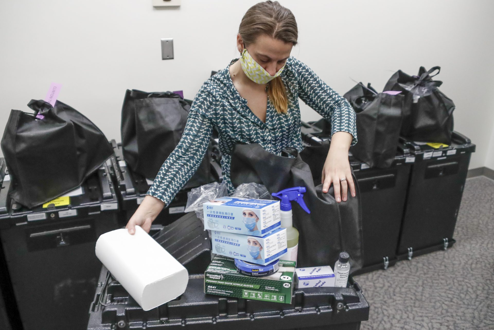 Butler County Bureau of Elections Registrar, Chantell McCurdy packs one of the COVID-19 cleaning and preparedness precinct kits with equipment as protective masks, gloves, hand sanitizers, wipes and sprays for sanitizing, for poll workers for Pennsylvania's June 2nd Primary election before they are sent out from the offices Thursday, May 28, 2020, in Butler, Pa.