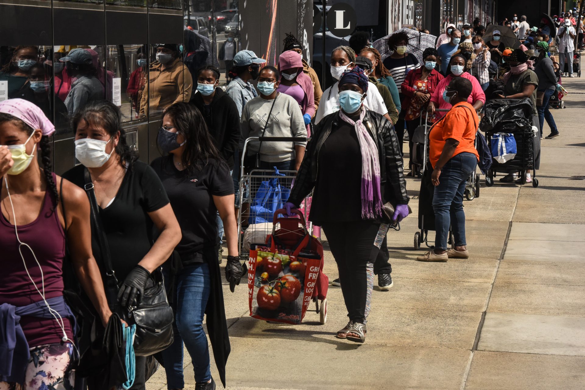 People wait in a long line to receive a food bank donation at the Barclays Center on May 15 in Brooklyn, N.Y. Across the country, cities and towns are dealing with the highest unemployment rates since the Great Depression.