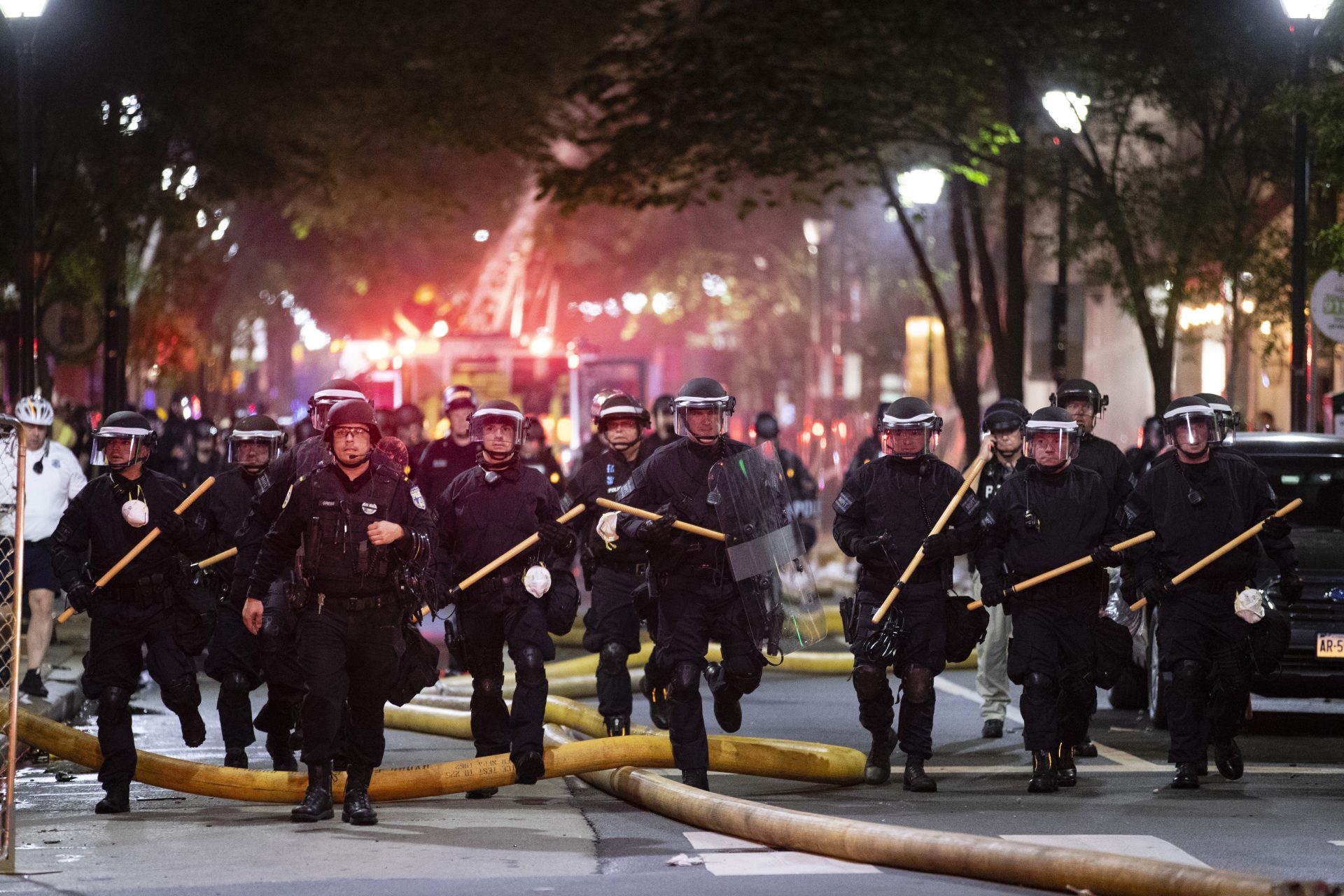 Police push down a street Saturday, May 30, 2020, in Philadelphia, during a protest over the death of George Floyd, a black man who was in police custody in Minneapolis. Floyd died after being restrained by Minneapolis police officers on Memorial Day. (