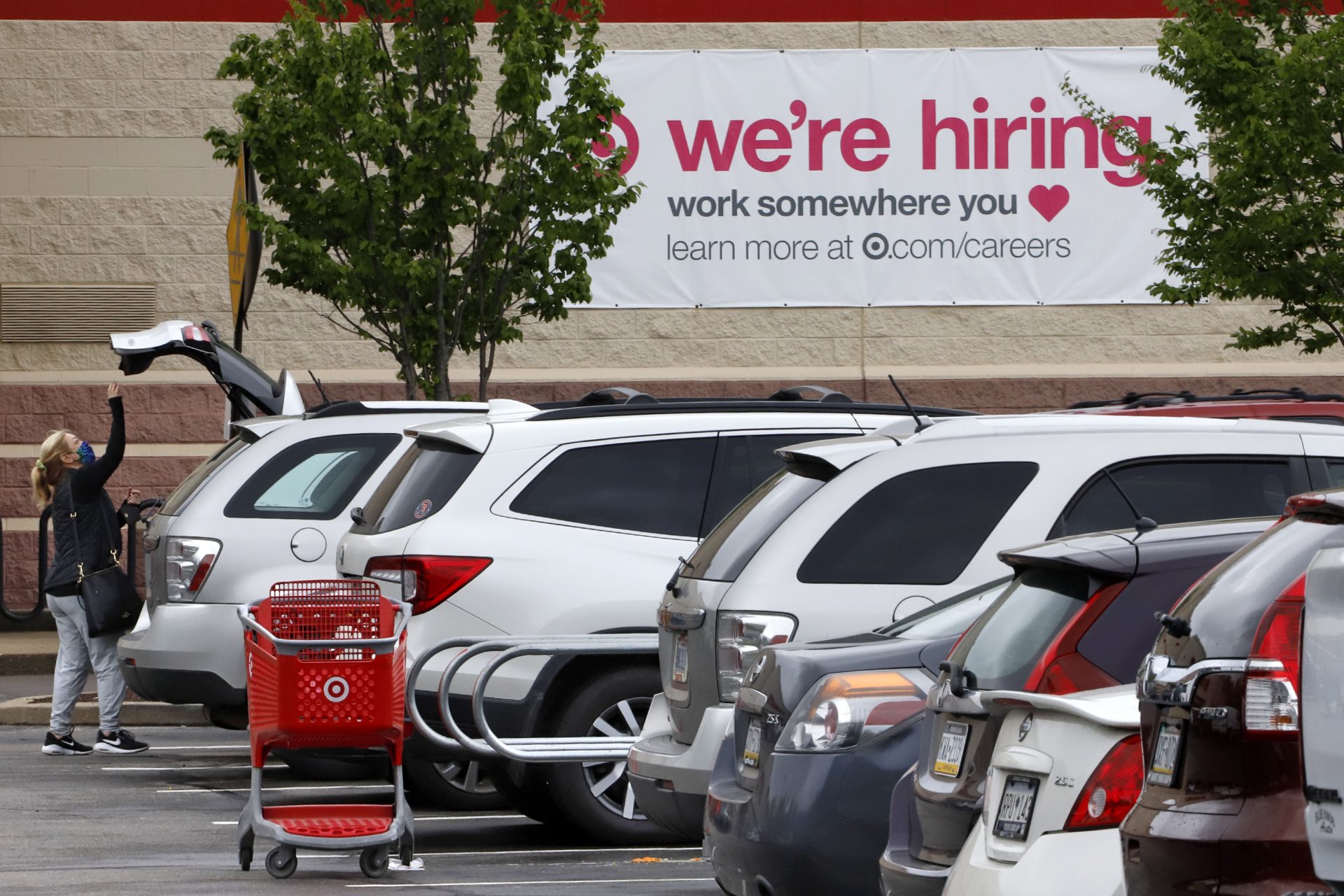A shopper loads her car after shopping at a Target store in Robinson Township, Pa., Wednesday, May 6, 2020.