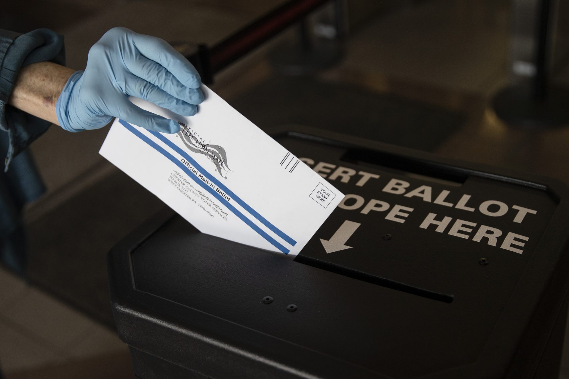 A voter cast her mail-in ballot at in a drop box in West Chester, Pa., prior to the primary election, Thursday, May 28, 2020. (AP Photo/Matt Rourke)