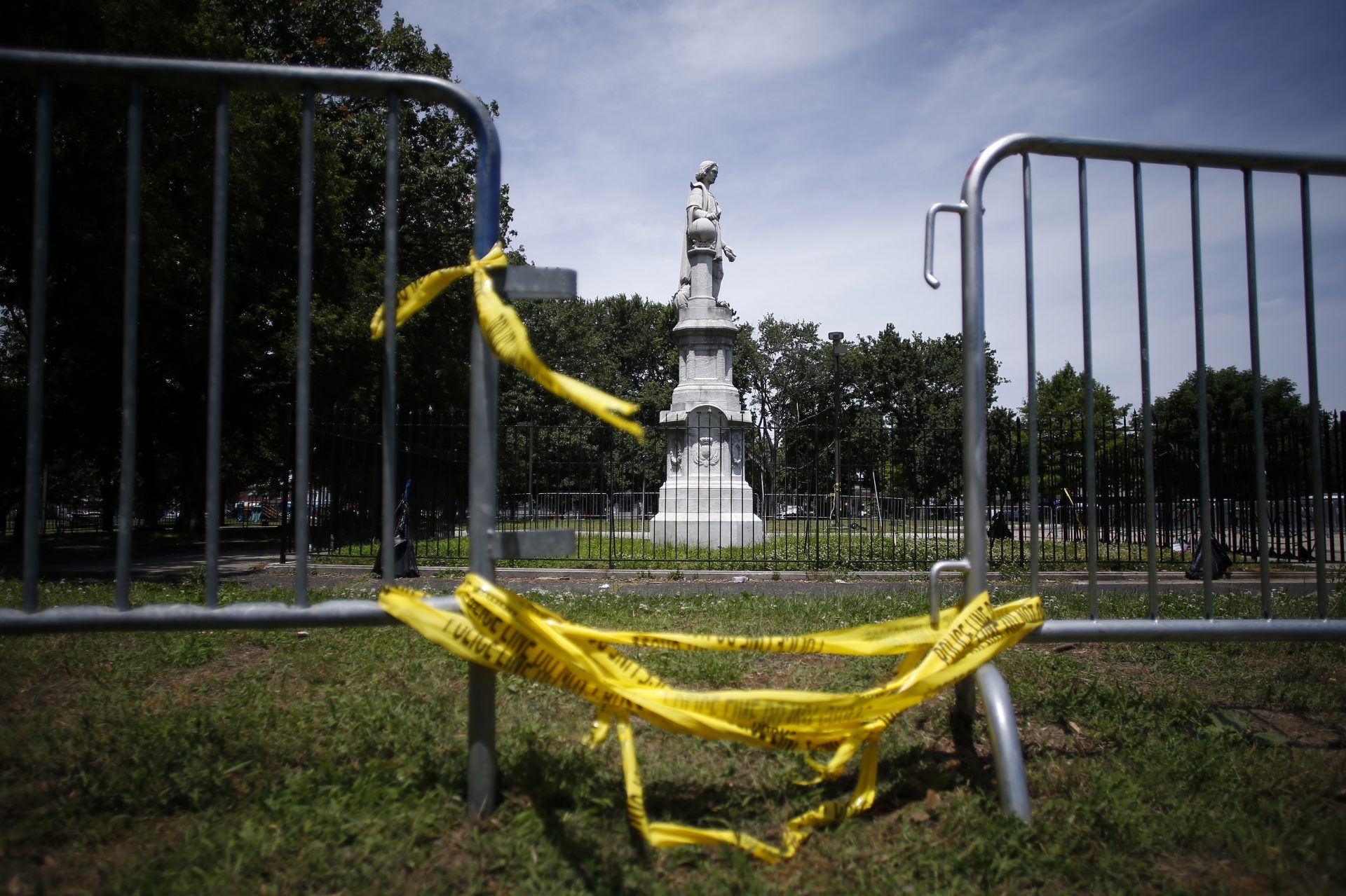 A statue of Christopher Columbus is seen behind barricades at Marconi Plaza, Monday, June 15, 2020, in the South Philadelphia neighborhood of Philadelphia.