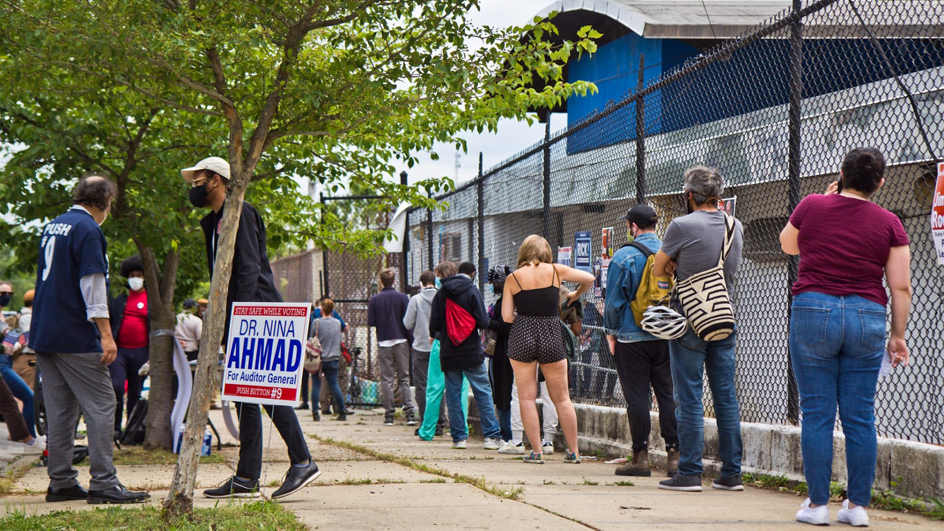 Voters wait in a socially distanced line outside their polling place in Philadelphia.